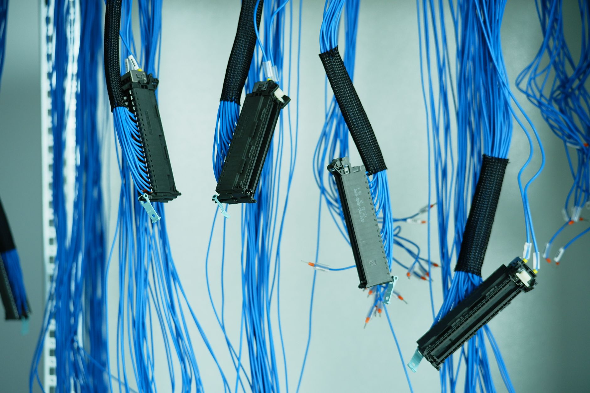 rows of network security appliances and patch-panel cabling inside a government data center, shot from a low angle looking down a long equipment aisle