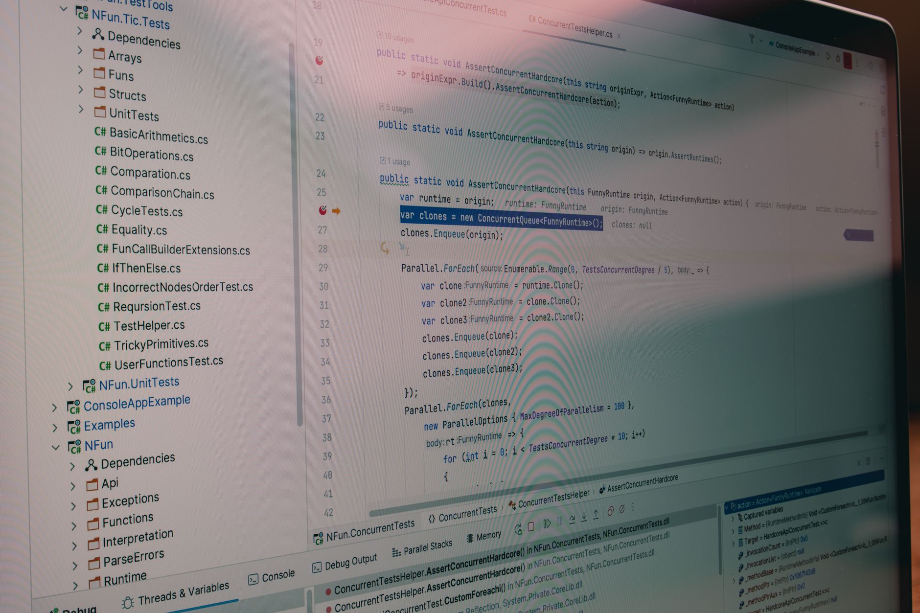 close-up of a laptop screen displaying a multilingual adversarial prompt test interface with color-coded threat detection indicators and language-switching toggle controls