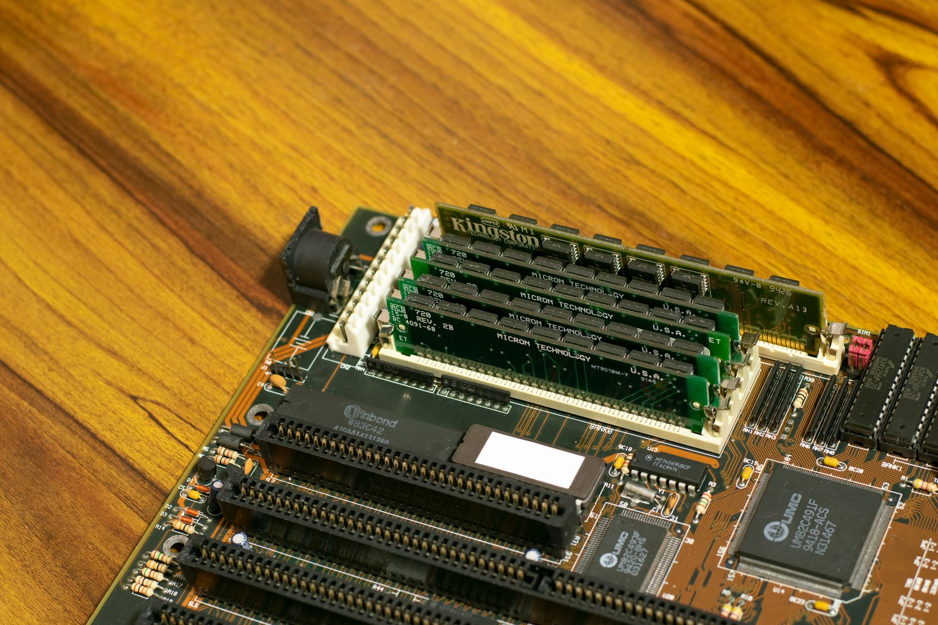 rows of compact edge AI accelerator modules mounted inside an automotive-grade embedded computing enclosure in a hardware testing lab