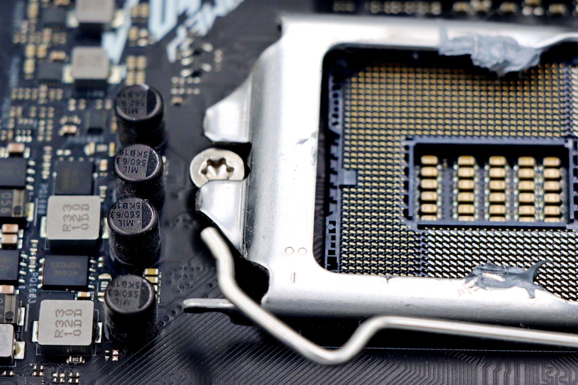 a close-up of a modern smartphone motherboard with a Snapdragon processor module visible under macro lighting, placed on an electronics workbench