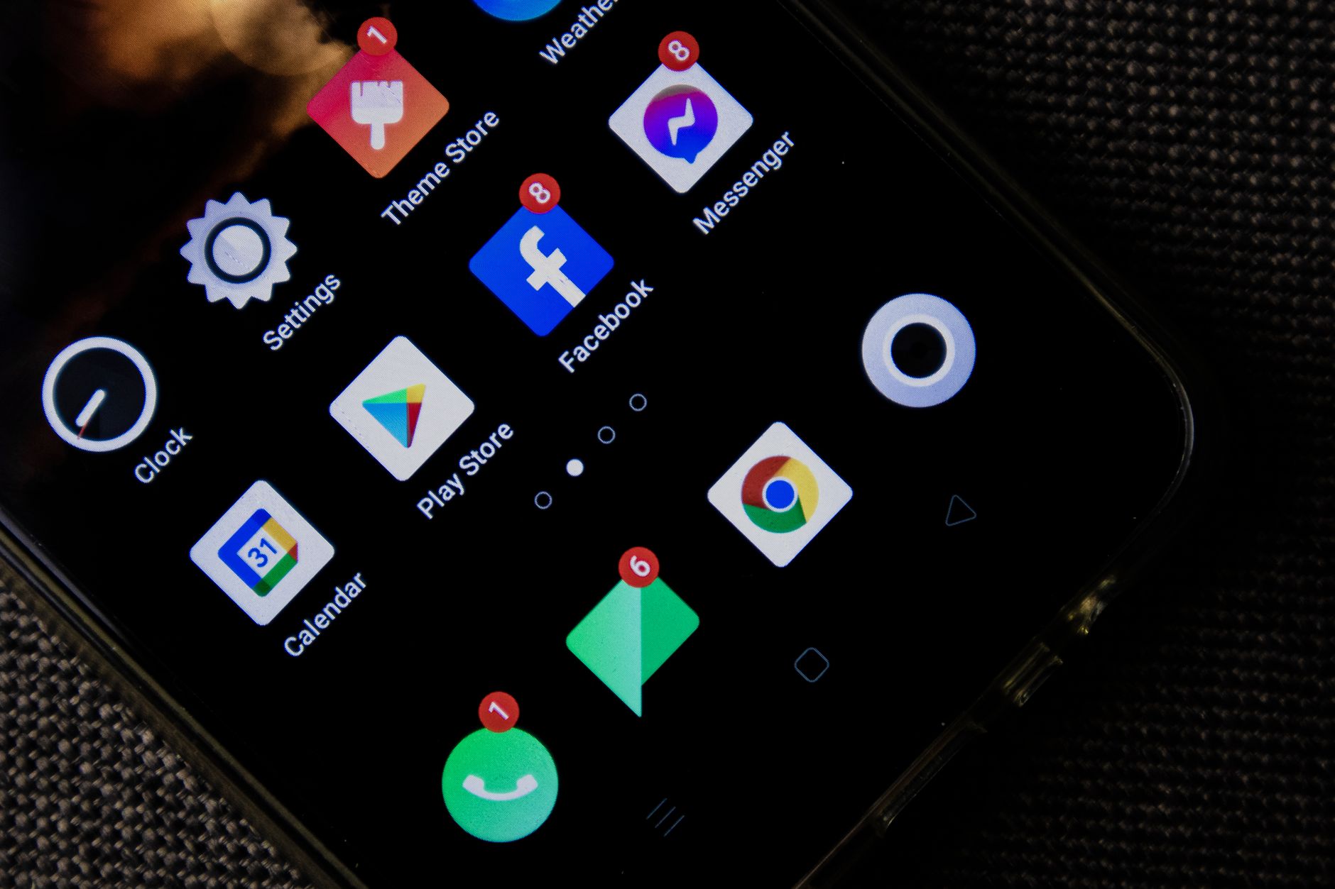 a close-up of a smartphone screen displaying a network connection settings menu with DNS and TLS configuration options, resting on a dark matte desk surface