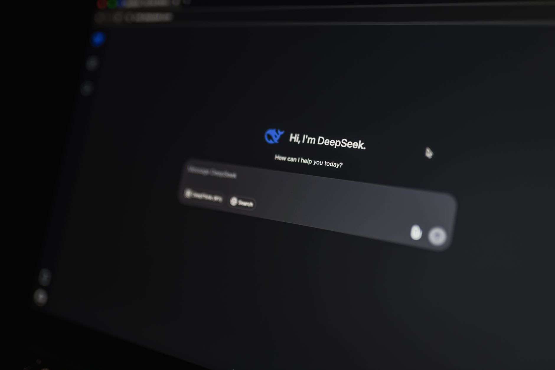 a close-up of a MacBook Pro screen displaying an AI writing assistant interface with suggested text edits, on a wooden desk in soft natural light
