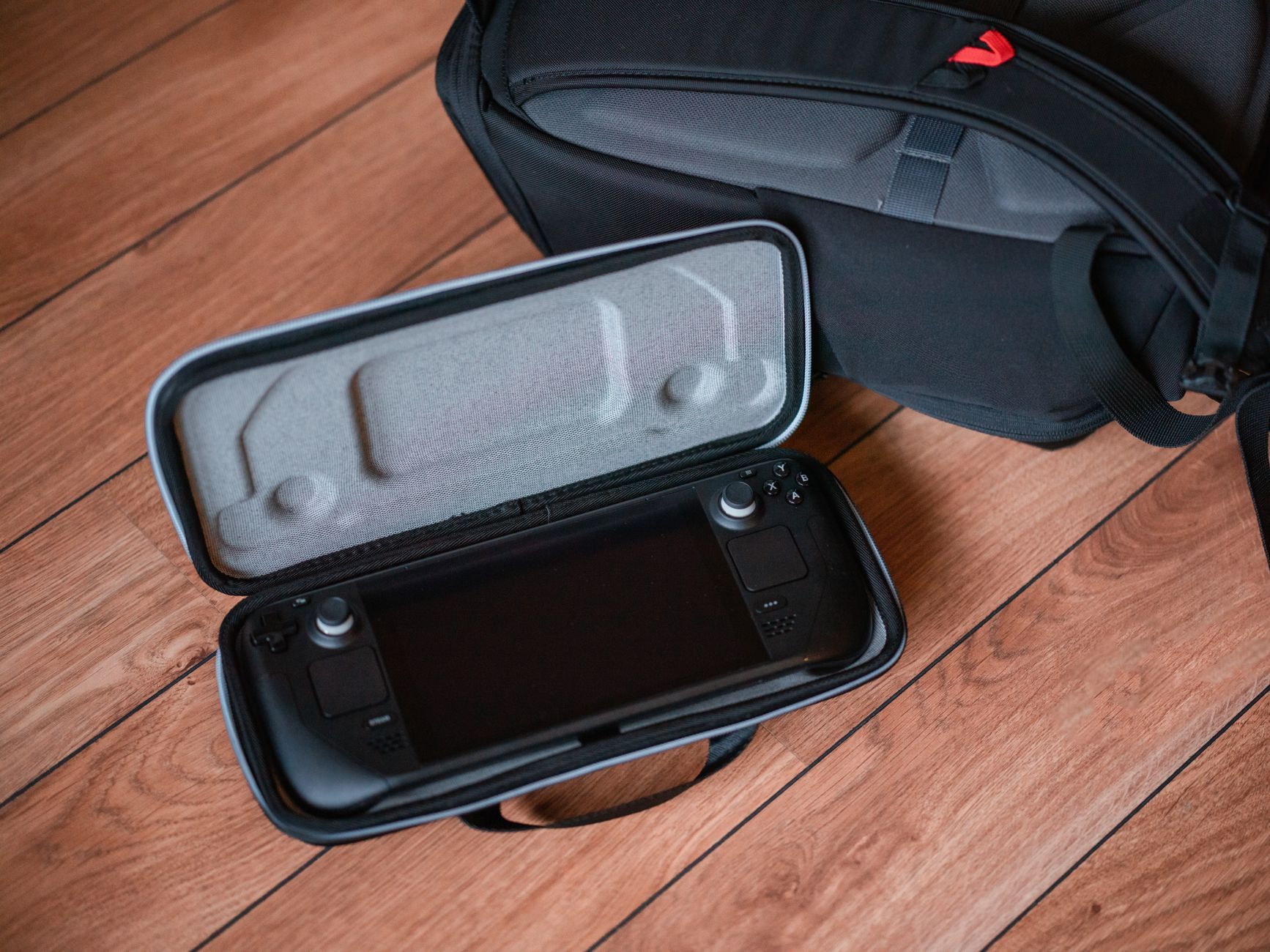 close-up of the control panel and digital display on a portable compression boot device sitting on a gym bag