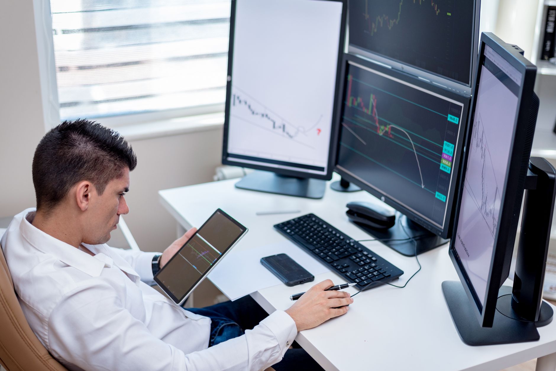 a sprawling open-plan AI research office with rows of workstations, large monitors displaying data visualizations, and whiteboards covered in equations