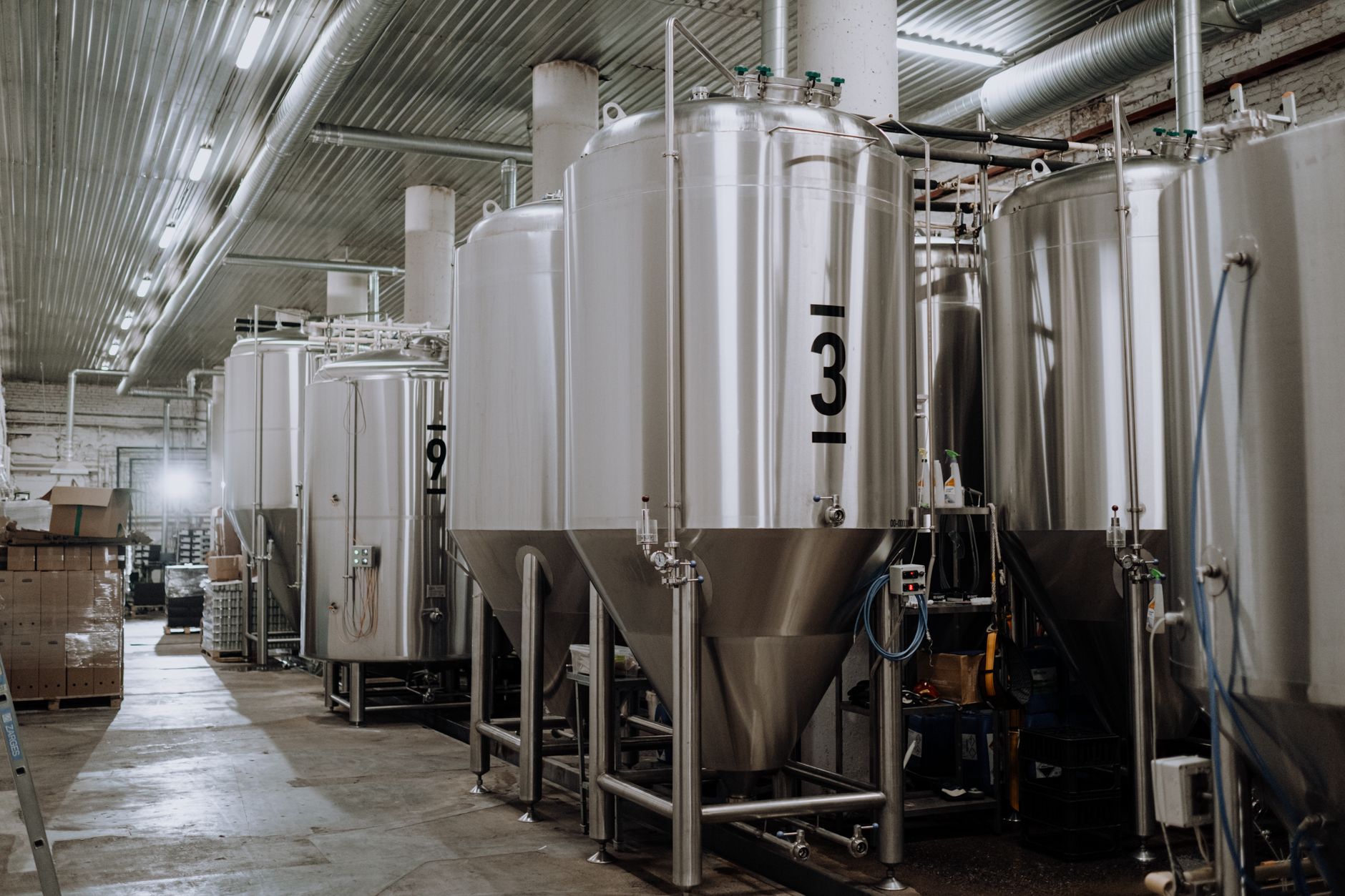 interior of a flotation plant processing facility with large cylindrical tanks and ore separation equipment under industrial lighting