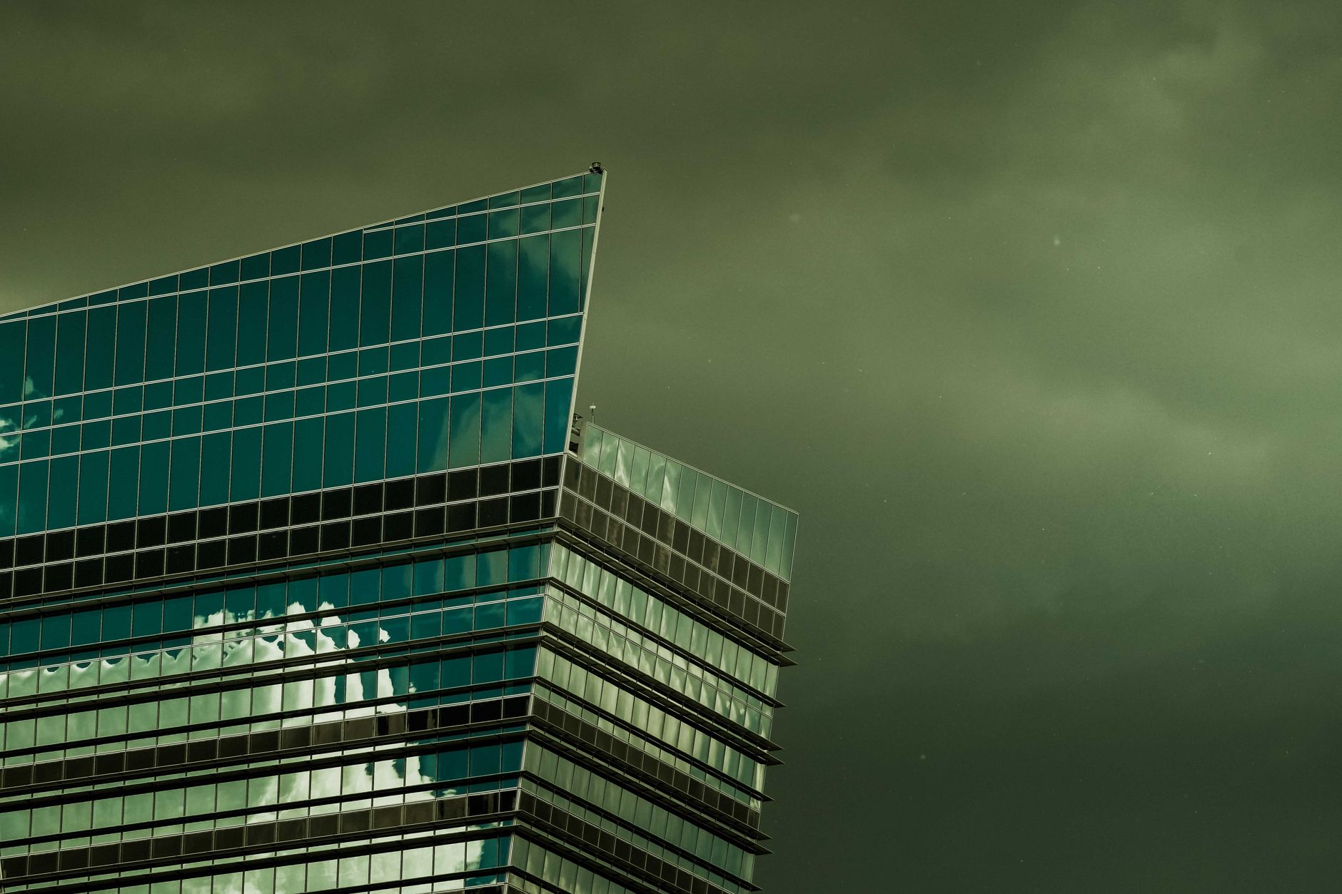 exterior of a modern biotech office building with glass facade, pharmaceutical signage visible on entrance, overcast sky