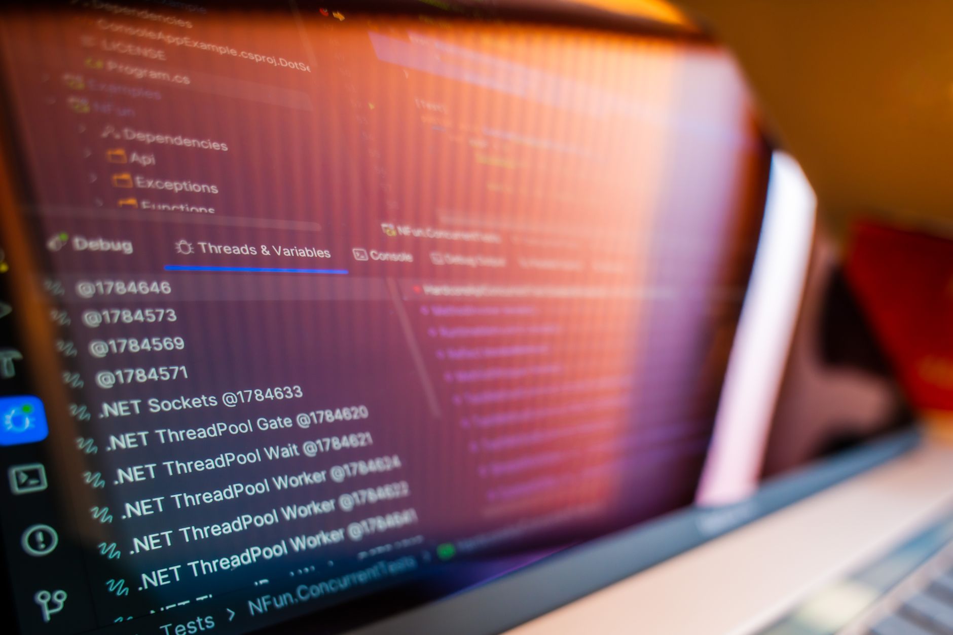 a developer's monitor displaying lines of API call syntax against a dark-mode code editor interface, keyboard and coffee cup in the foreground