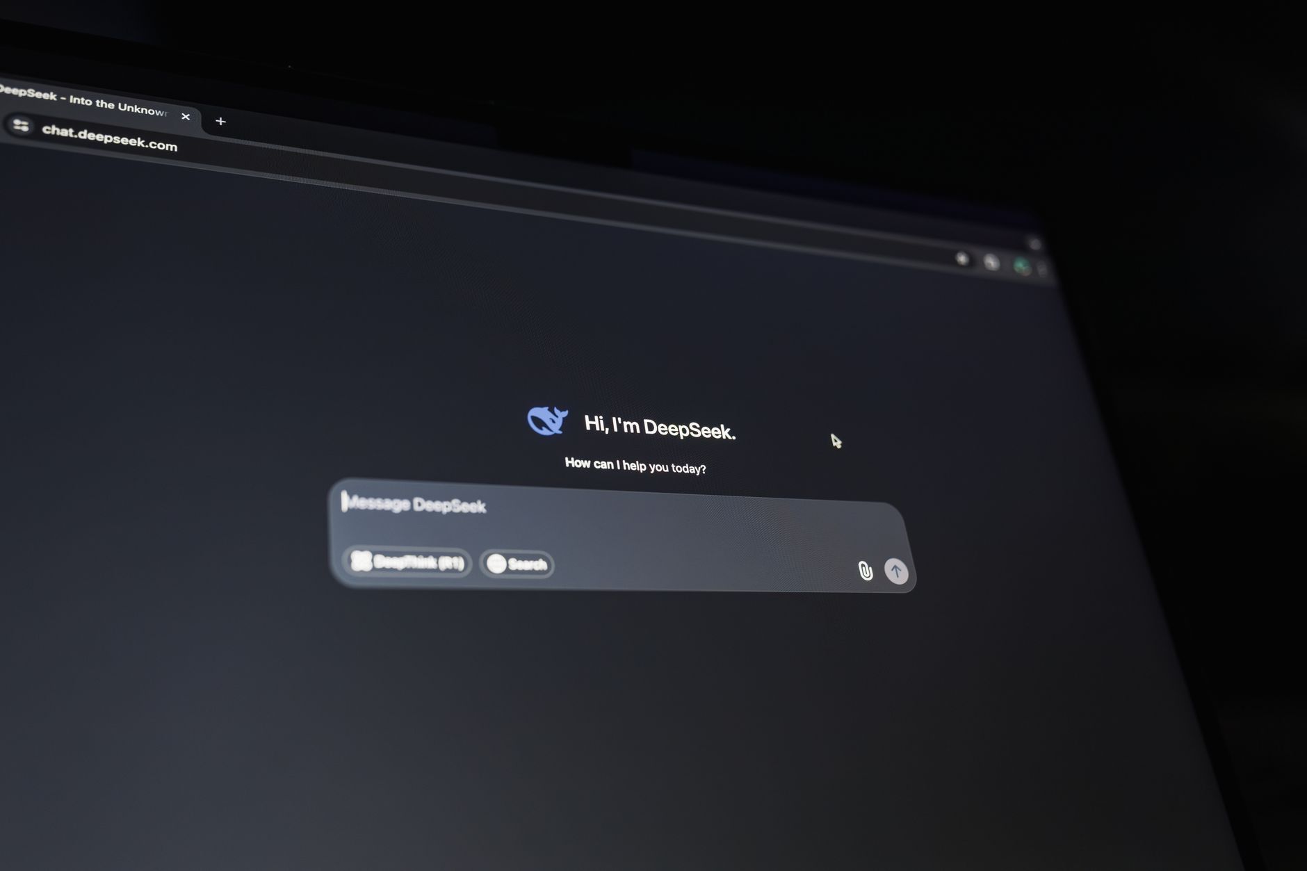 a minimalist product interface displayed on a laptop screen sitting on a clean wooden desk, showing an AI chat assistant with multiple active conversation threads visible