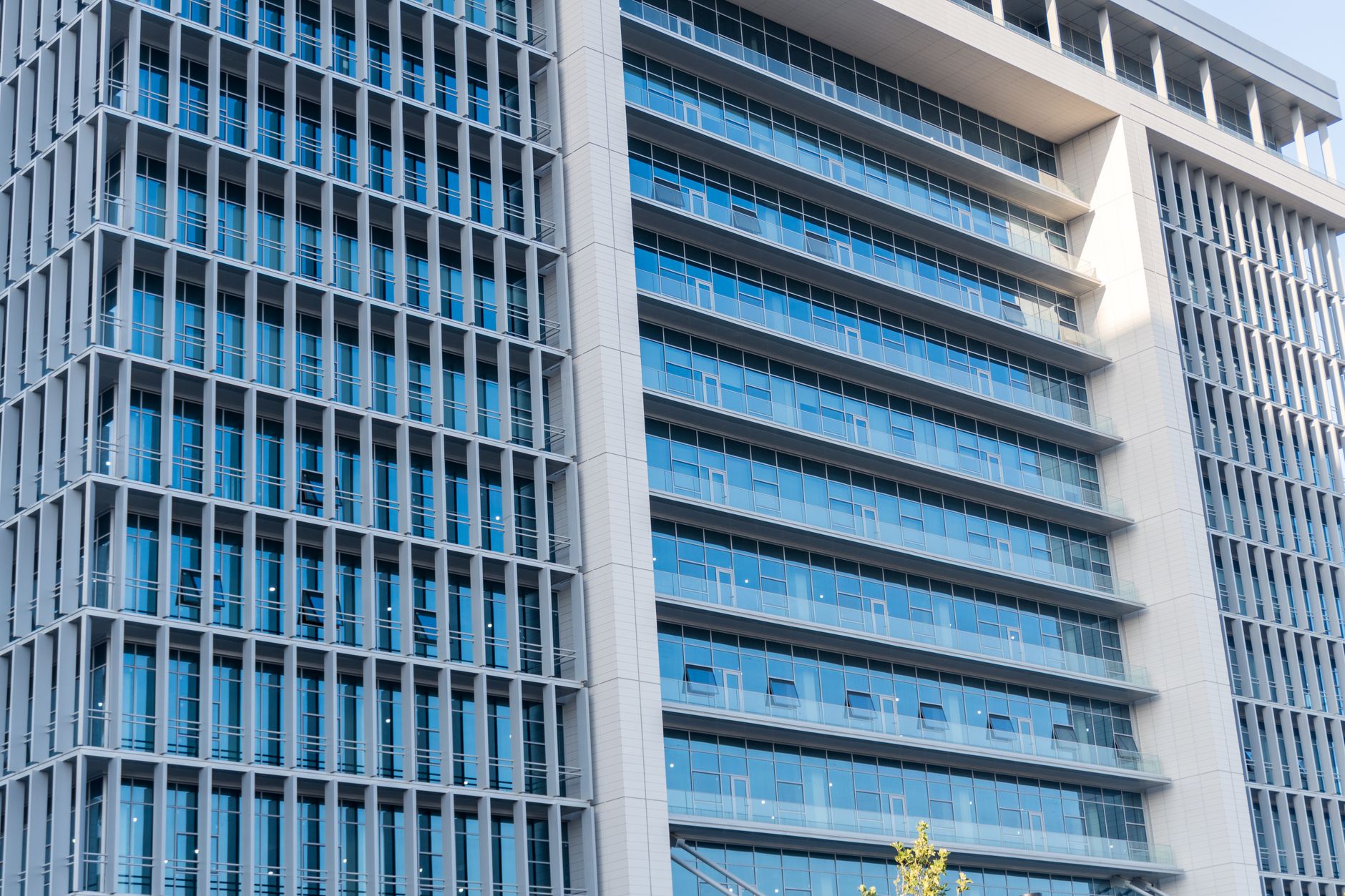 exterior of a modern financial regulatory office building in Tel Aviv, glass facade reflecting a city skyline at midday
