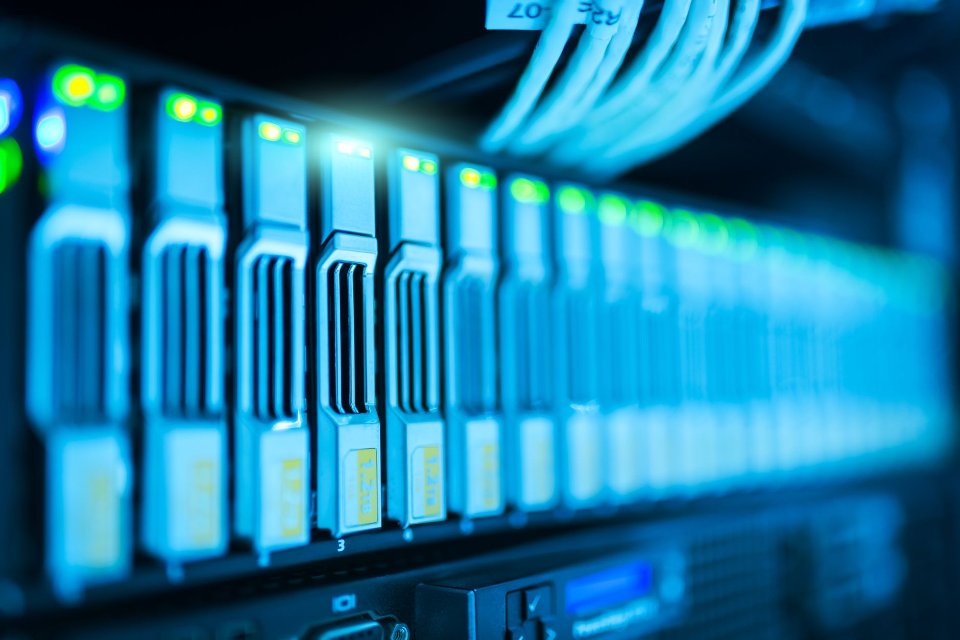 rows of high-performance GPU server racks inside a data center corridor with blue indicator lights and overhead cable trays