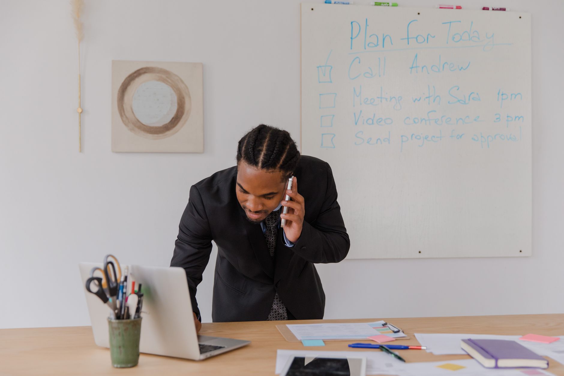 a modern open-plan startup office with empty desks, laptops closed, whiteboards filled with hand-drawn product roadmaps in the background