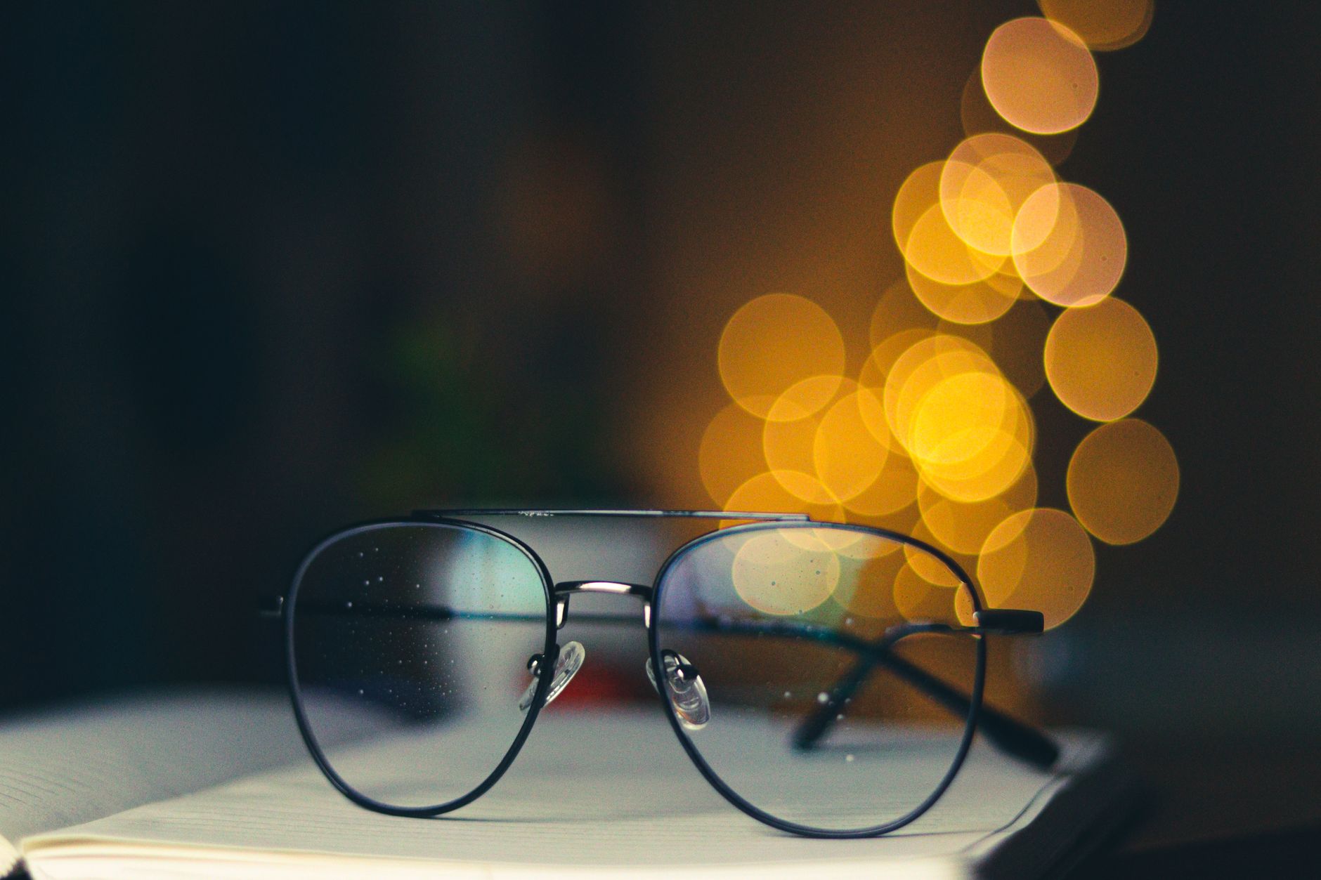a close-up of smart glasses lenses reflecting a blurred indoor public space, no identifiable faces visible