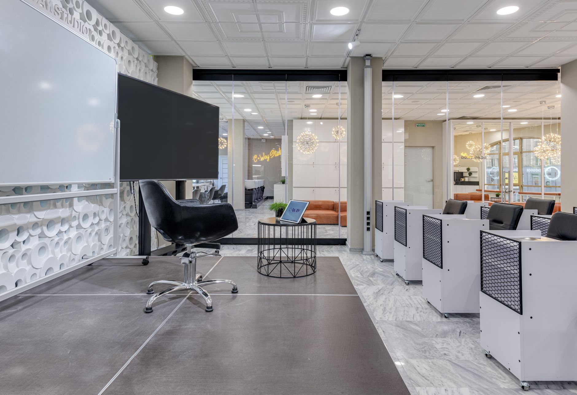 a glass-walled startup office with whiteboards covered in architecture diagrams, chairs pushed in, and overhead lights dimmed