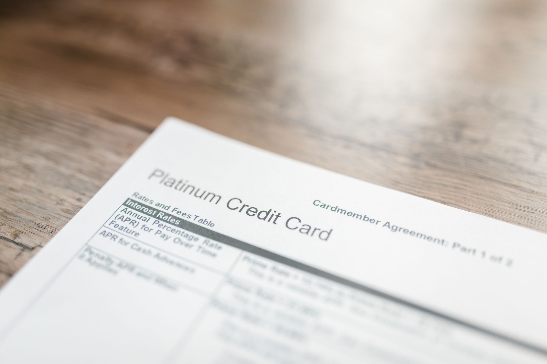 close-up of a financial shareholder ballot form on a conference table alongside a printed annual report, soft overhead lighting in a boardroom setting