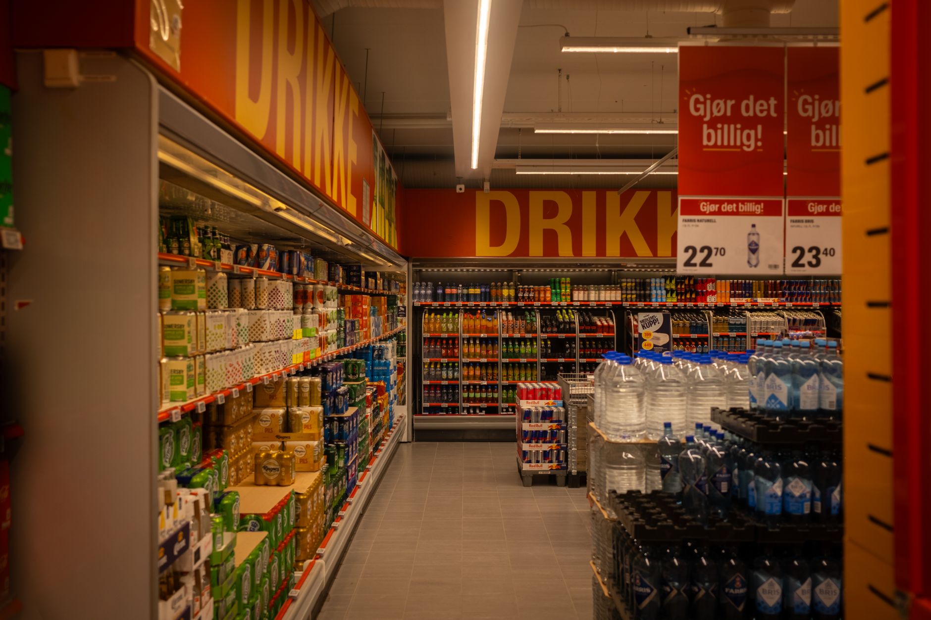 interior aisle of an organic grocery store with bulk bins, wooden shelving, and natural lighting from skylights overhead