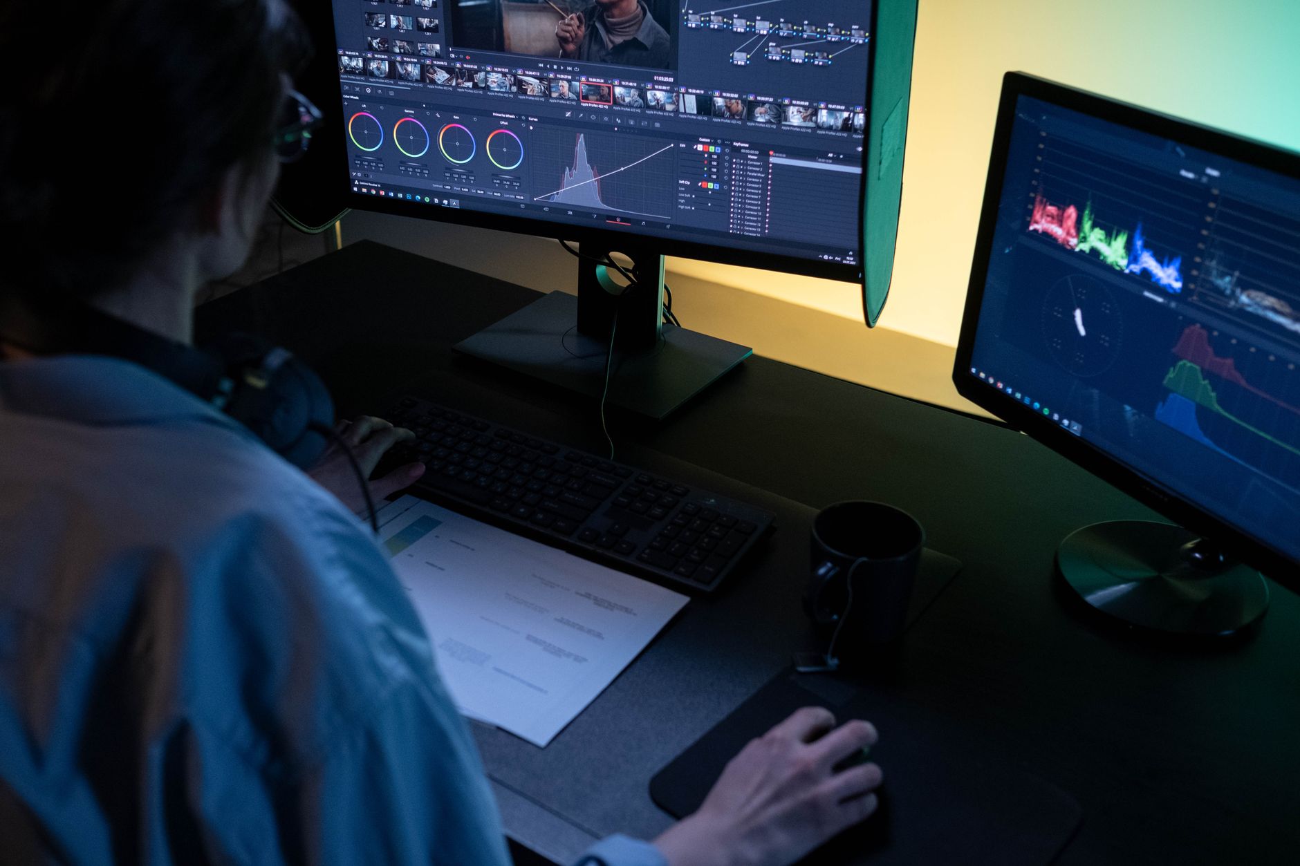 a dimly lit AI research lab with multiple monitor screens displaying neural network diagrams and red-flagged evaluation logs, workstations arranged in a curved row