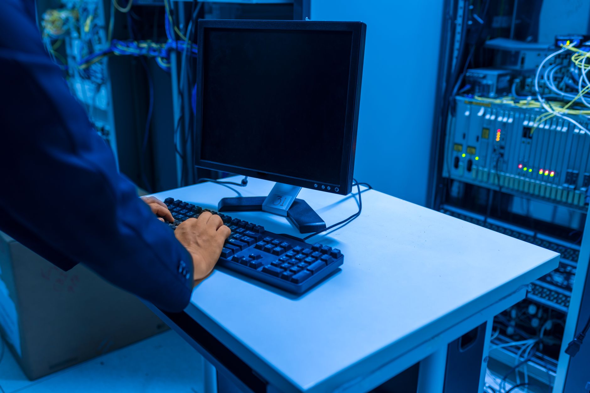 a rack-mounted print server unit with blinking status lights inside a corporate server room, cables running neatly along a cable management tray