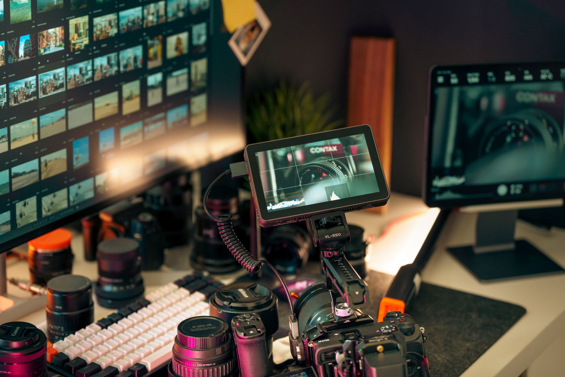 a single desktop workstation in a cluttered broadcast editing suite displaying a frozen file-transfer progress bar at zero percent