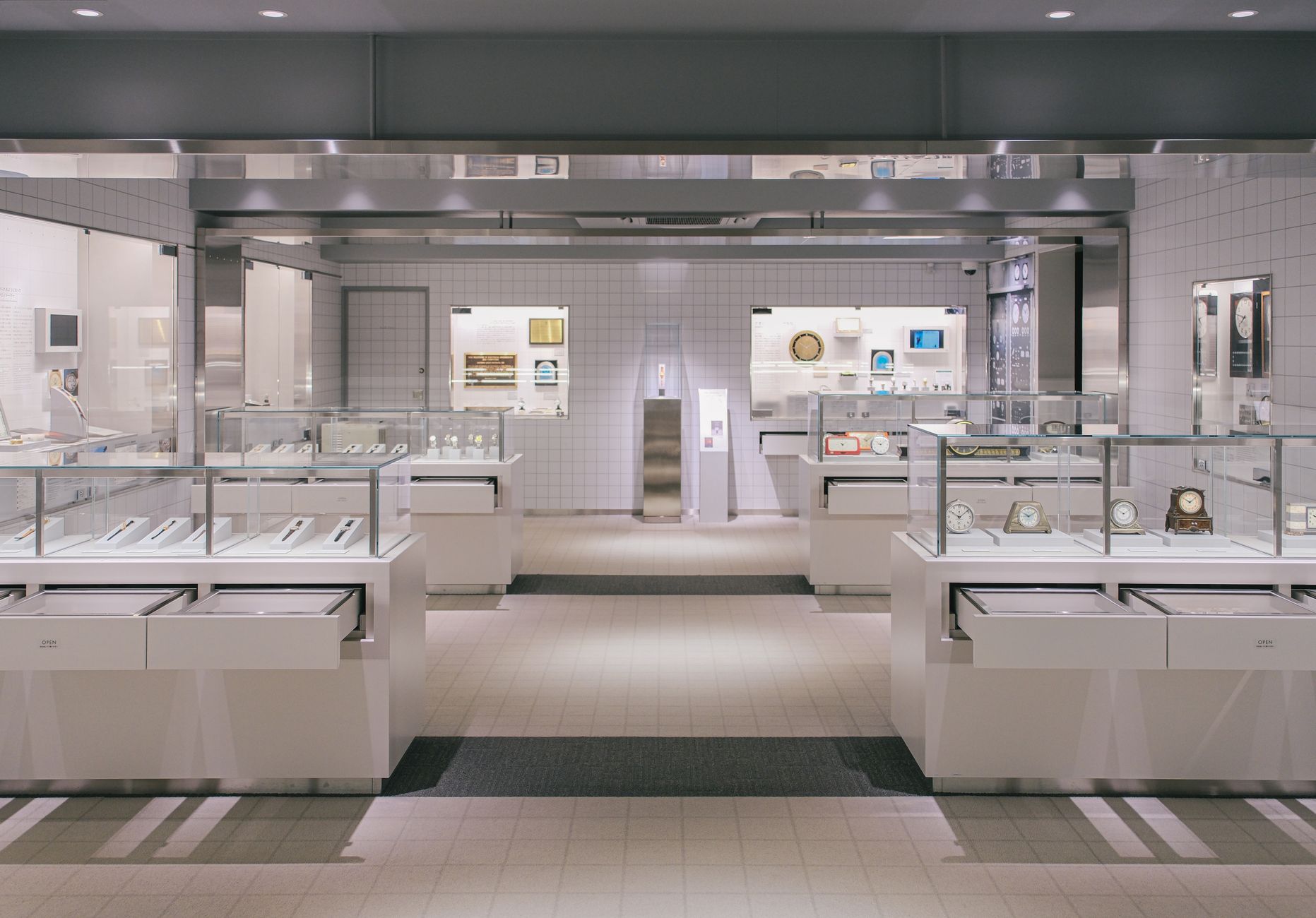 rows of branded gaming peripherals and accessories displayed on shelving inside a minimalist electronics showroom