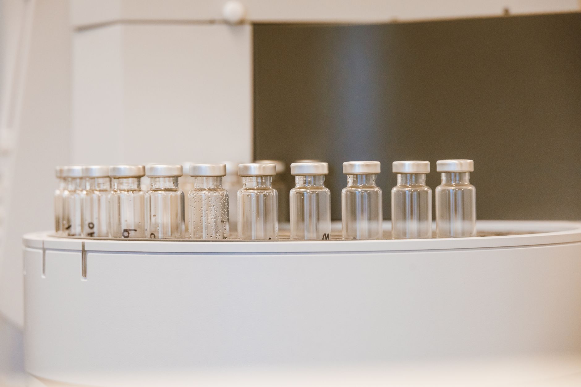 rows of NAND flash memory wafers arranged on a semiconductor production tray under cleanroom lighting
