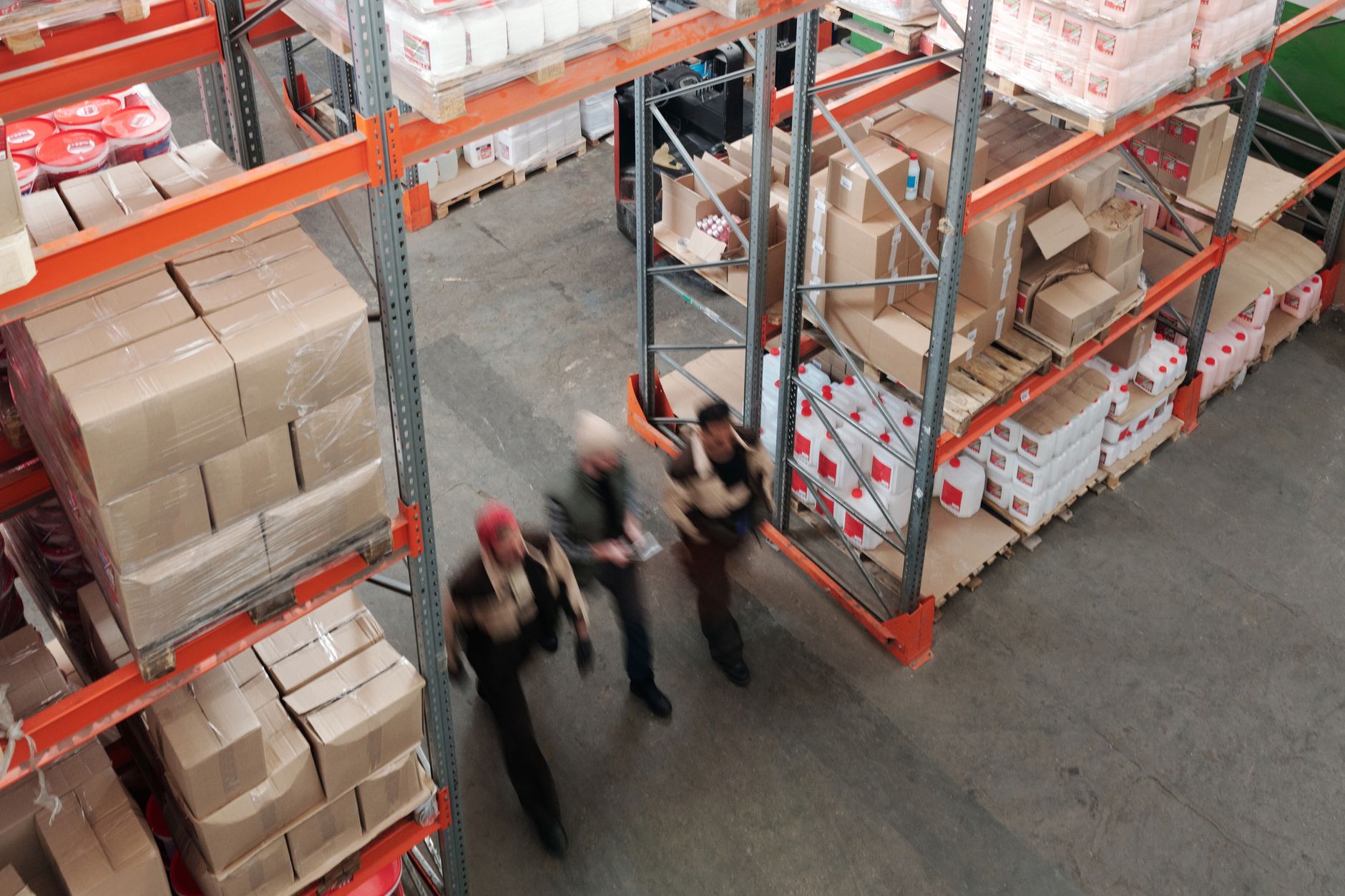 rows of cardboard shipping parcels stacked on conveyor belts inside a large warehouse fulfillment center