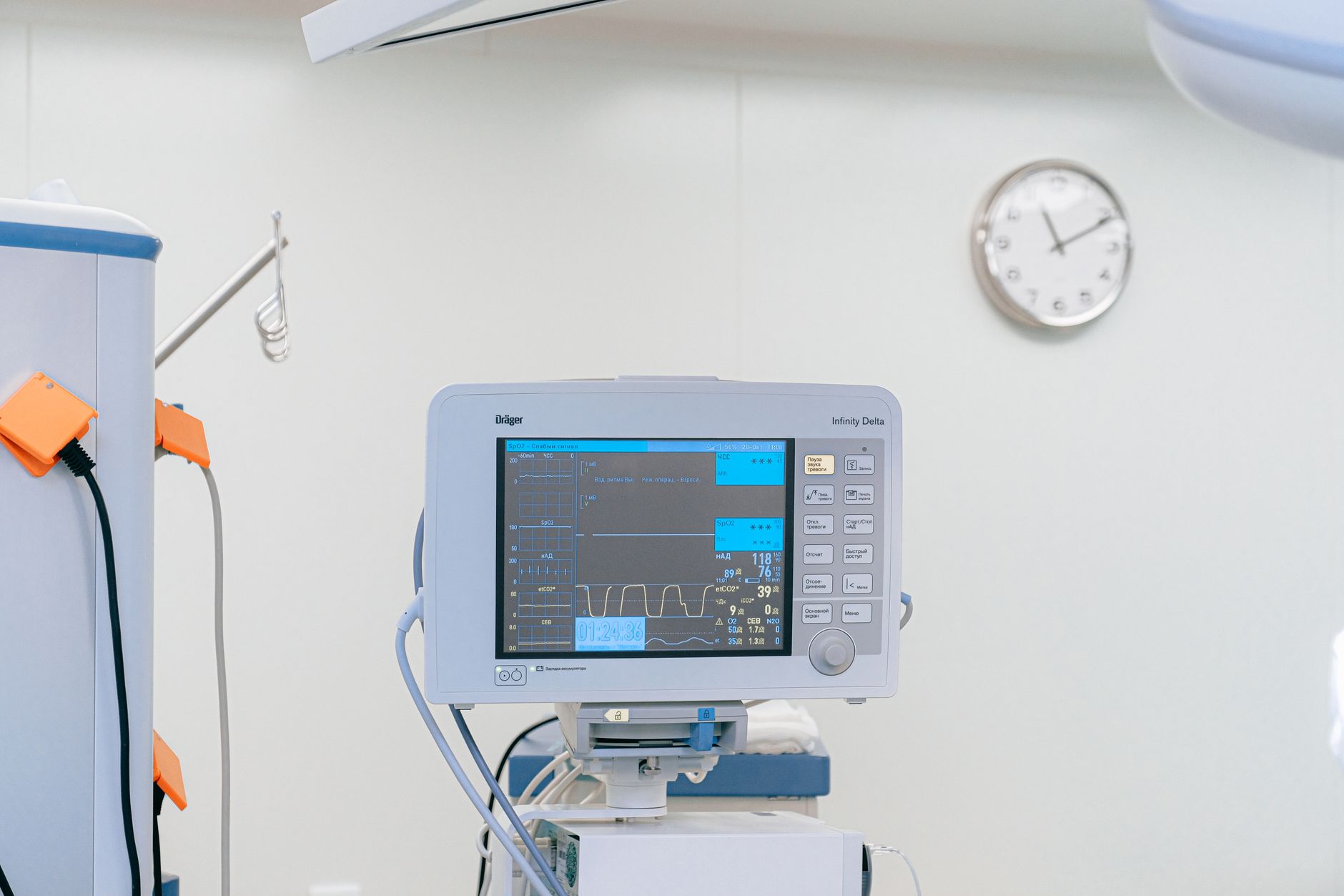a clinical command center in a hospital, multiple wall-mounted screens showing patient flow maps, bed occupancy grids, and predictive alert feeds