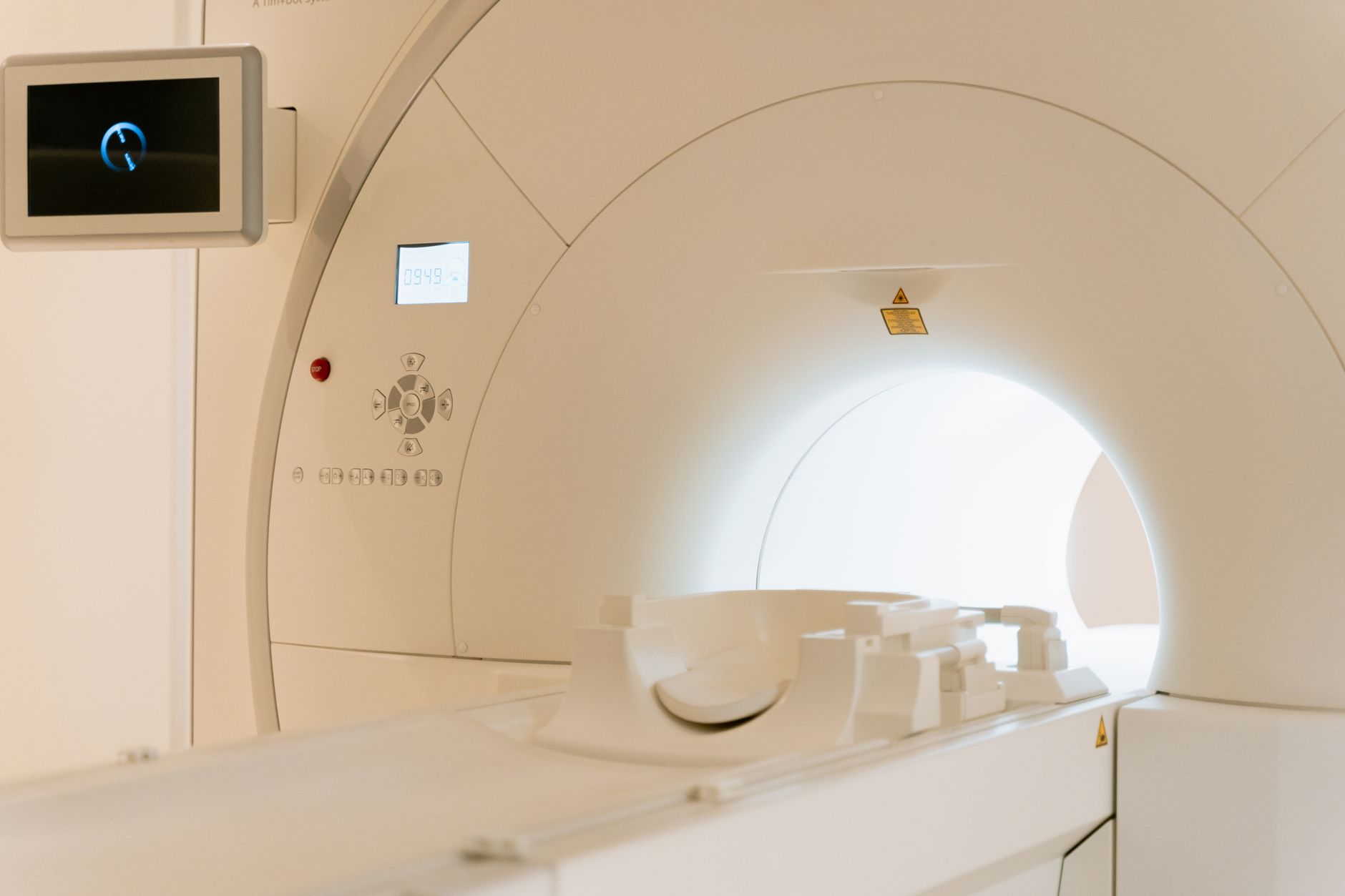 a row of audiology clinic fitting rooms with advanced diagnostic equipment mounted on walls and hearing instrument displays on counters