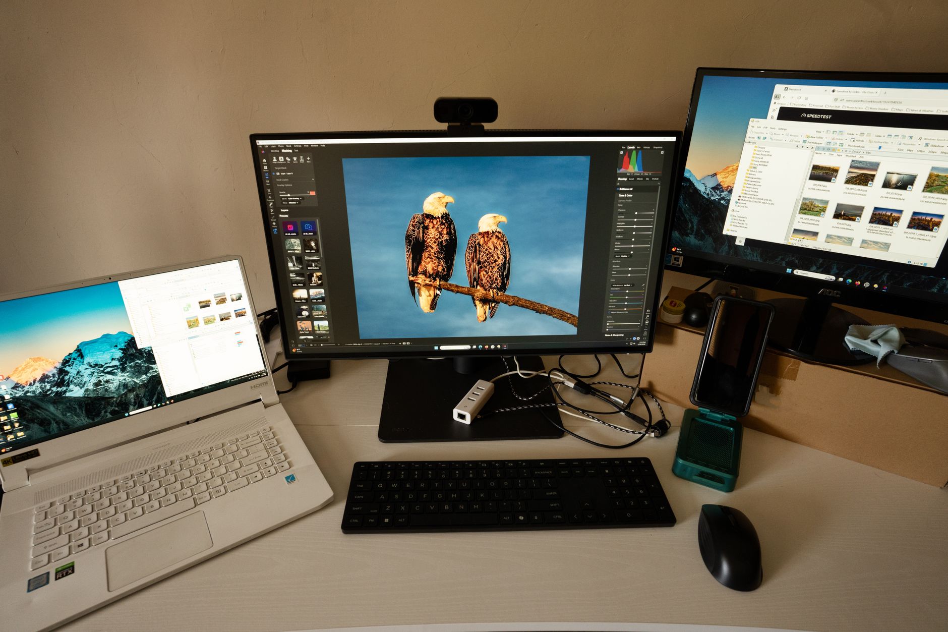 a wide-angle shot of a digital artist's workstation with multiple monitors displaying AI-generated image grids and generation prompts on screen