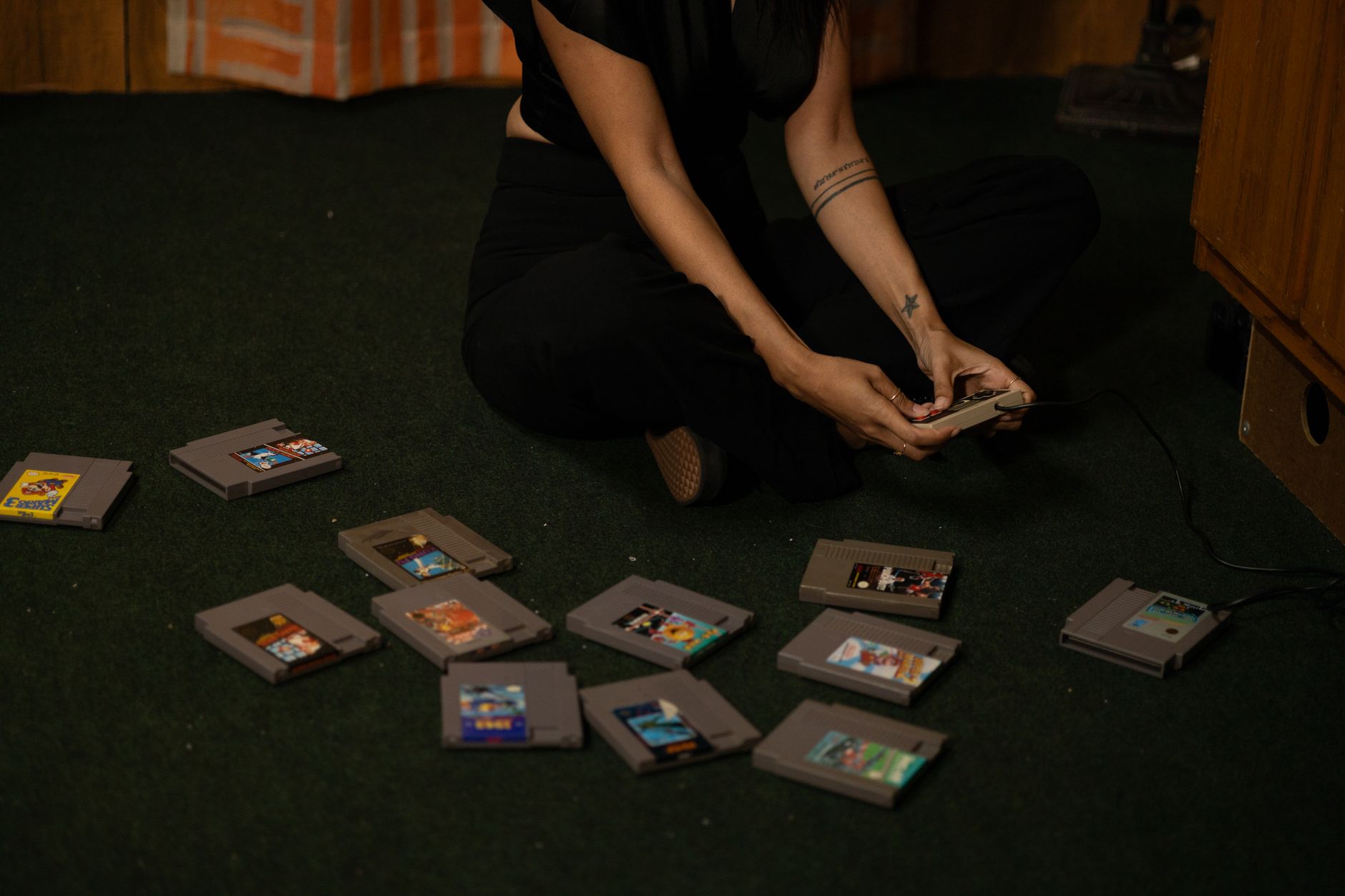 a vintage gaming console and cartridges arranged on a shelf next to a laptop showing an empty online lobby screen