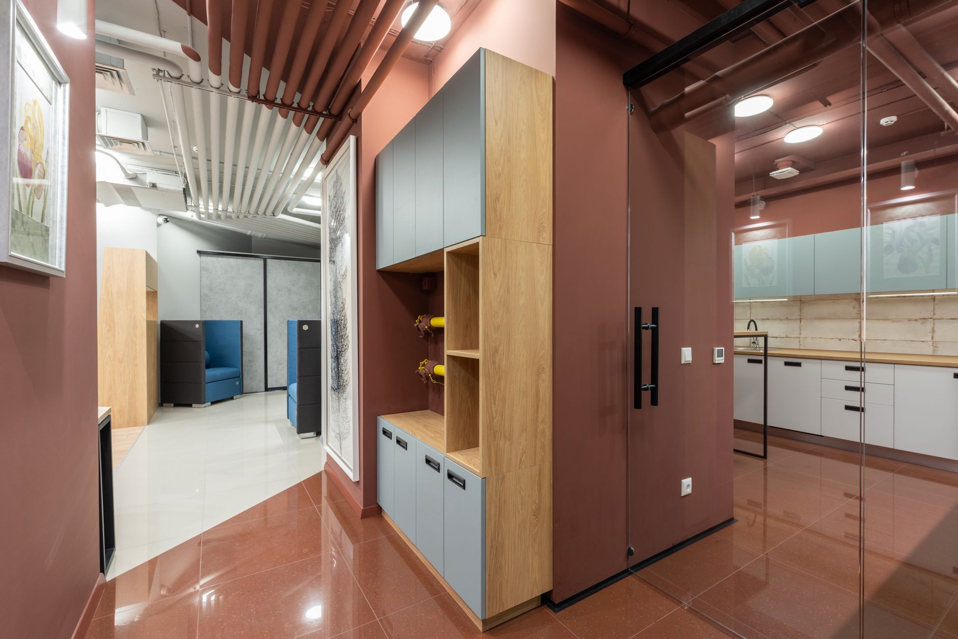 a wide-angle view of a modern hospital research wing corridor with glass-walled laboratory spaces visible on both sides