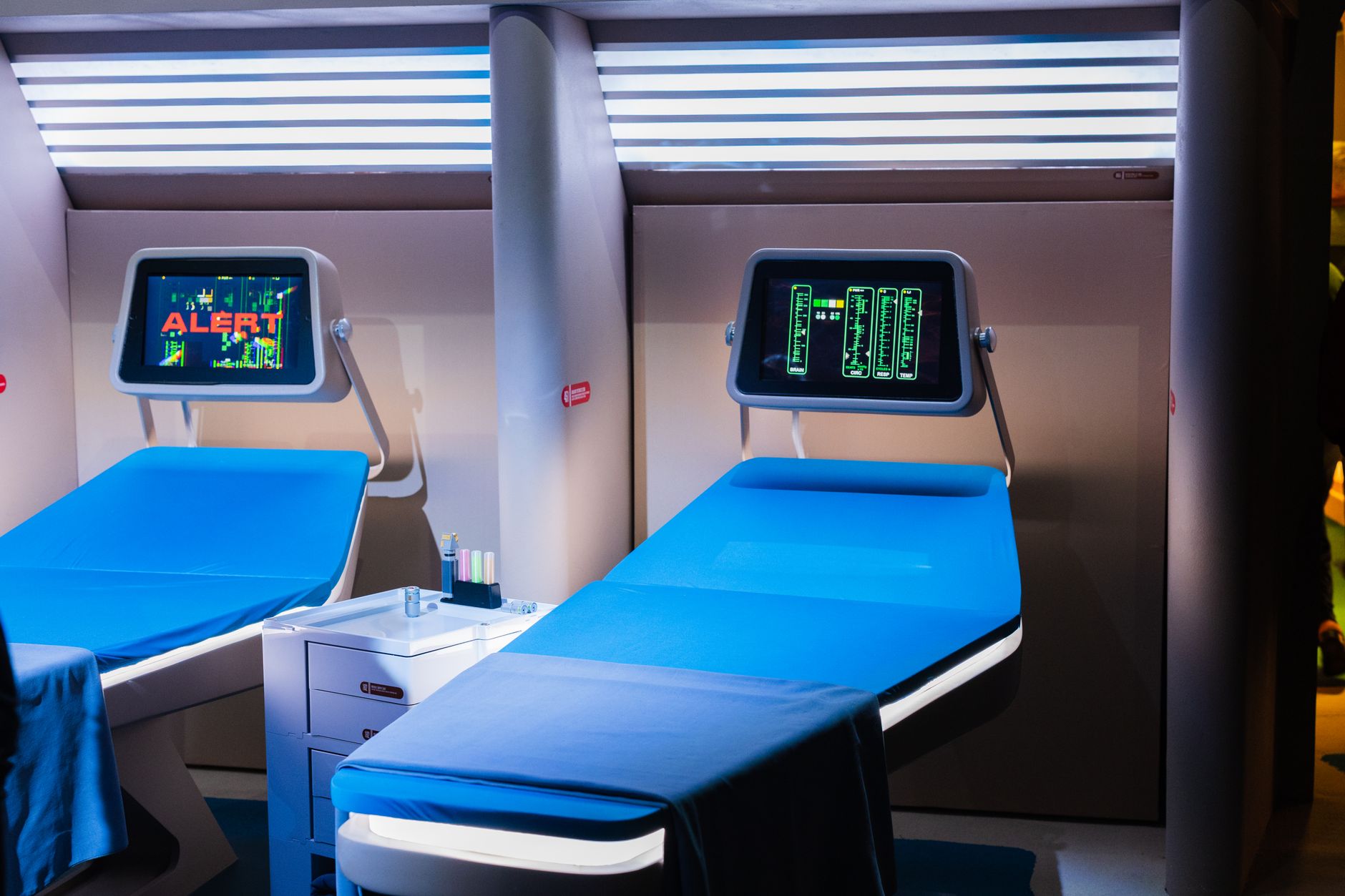 a modern preventive health clinic interior with diagnostic equipment, ergonomic consultation pods, and floor-to-ceiling windows overlooking an urban skyline