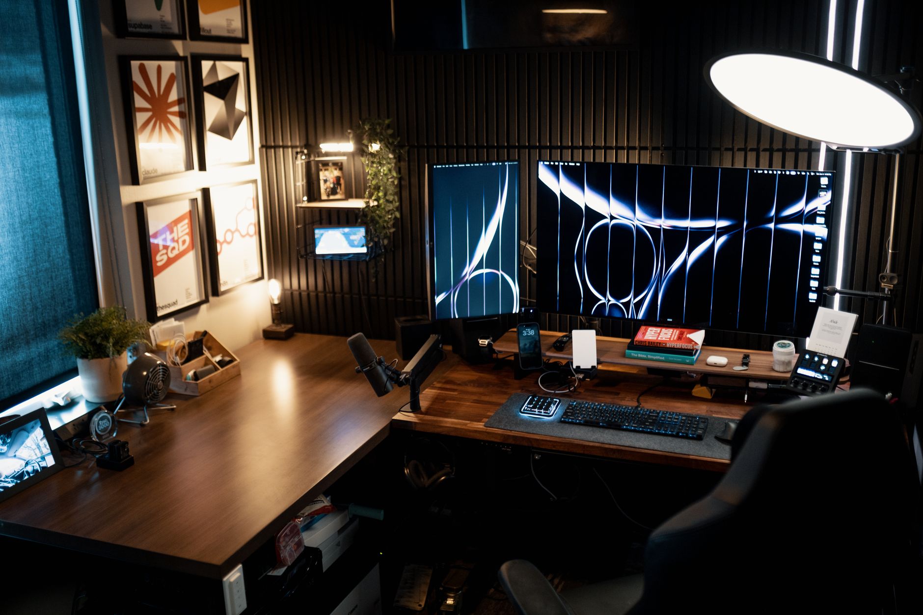 a modern open-plan tech office at night with multiple large monitor screens displaying workflow automation dashboards and data pipelines, shot from a wide angle with the screens as the focal point
