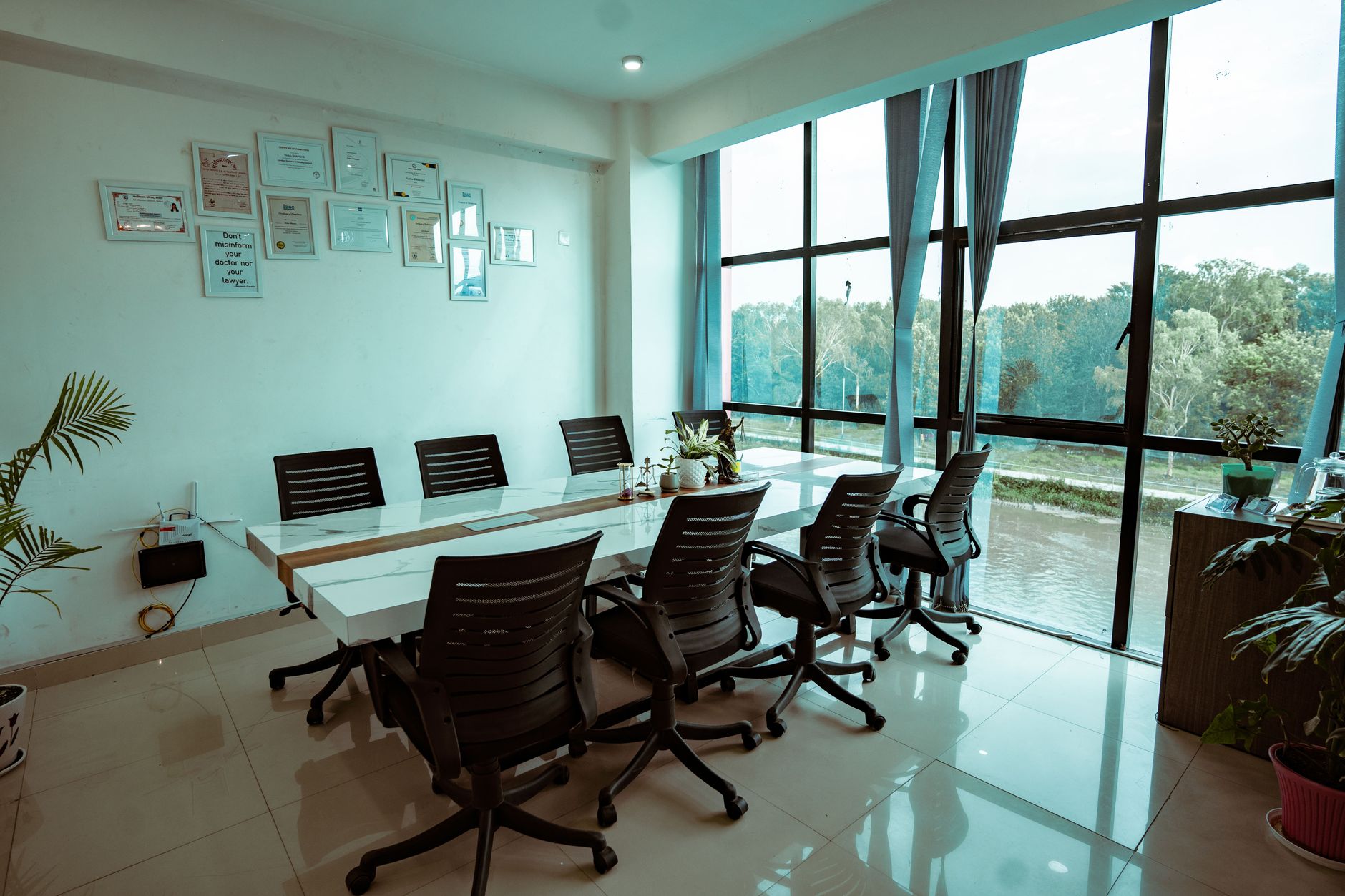a large conference room with empty chairs arranged around a long table, a projected slide showing a flowchart of AI governance frameworks visible on the wall