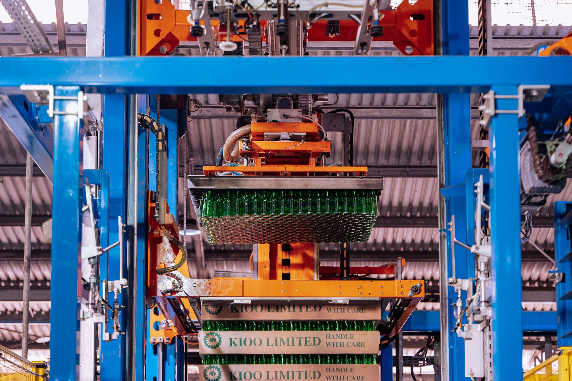 a high-throughput liquid handling robot arm positioned over a multi-well plate inside a pharmaceutical research facility
