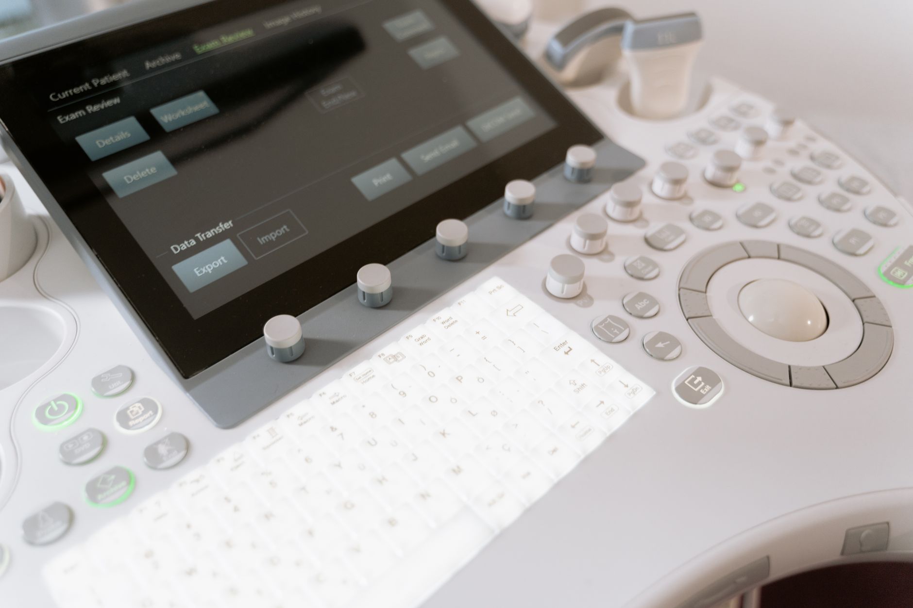 close-up of a medical workstation screen displaying anonymized patient data dashboards in a clinical office setting