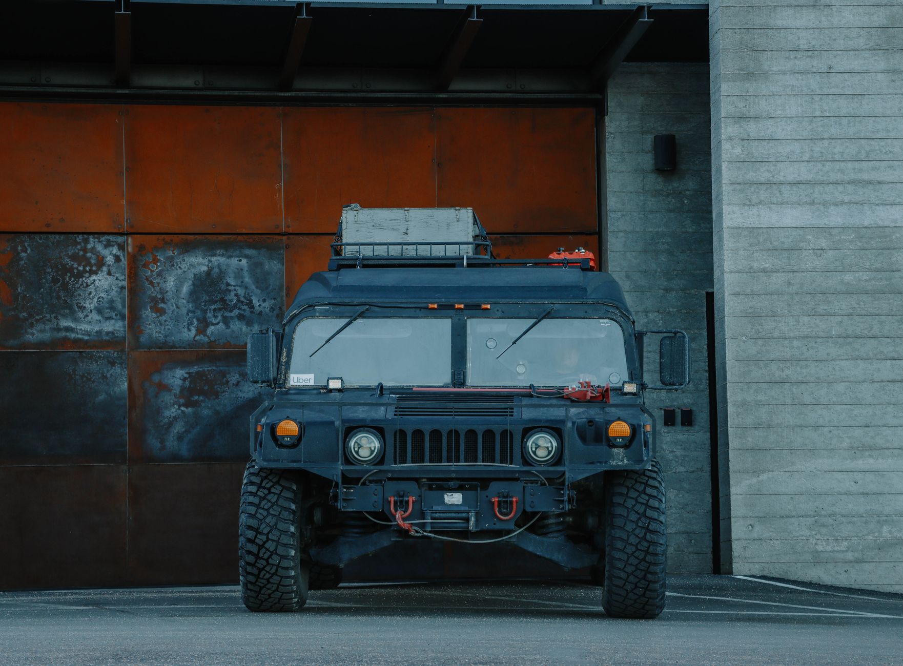 a solid-state LiDAR sensor unit mounted on a military-grade vehicle chassis inside a testing facility, harsh lighting casting sharp shadows across the device housing