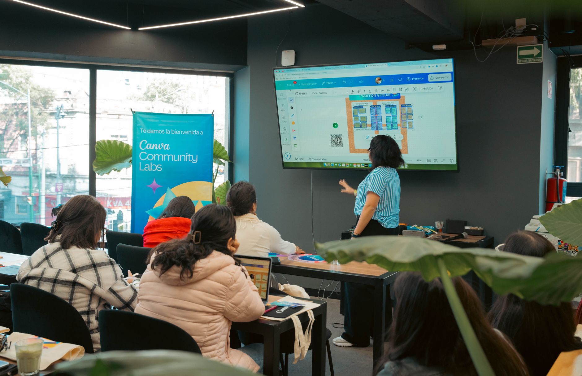 a wall-mounted interactive digital whiteboard in a modern classroom displaying a simple AI decision-tree diagram, chairs arranged in a semicircle in the foreground