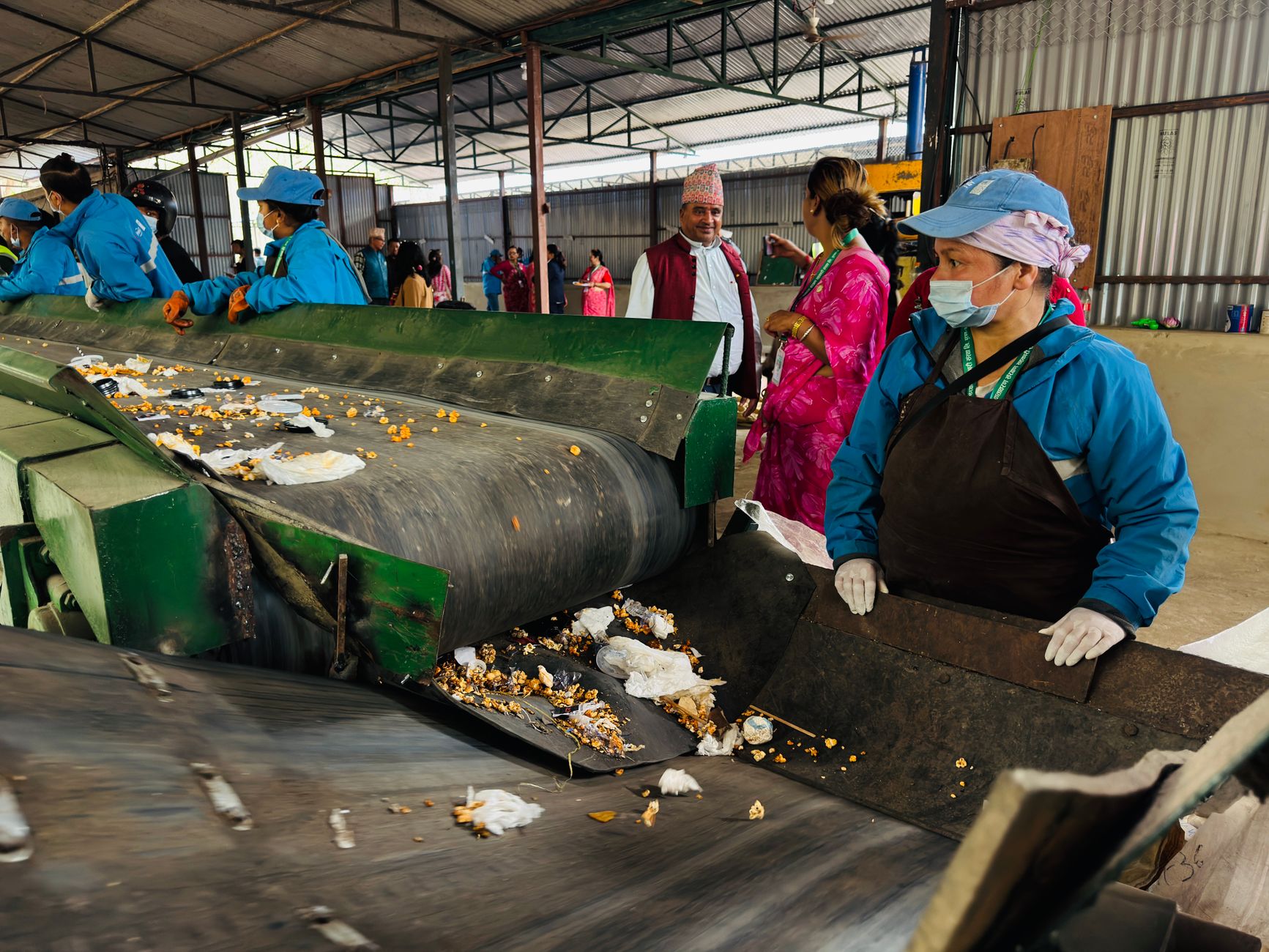 a modern recycling facility interior showing automated conveyor belts sorting materials under industrial lighting, no people as focal point
