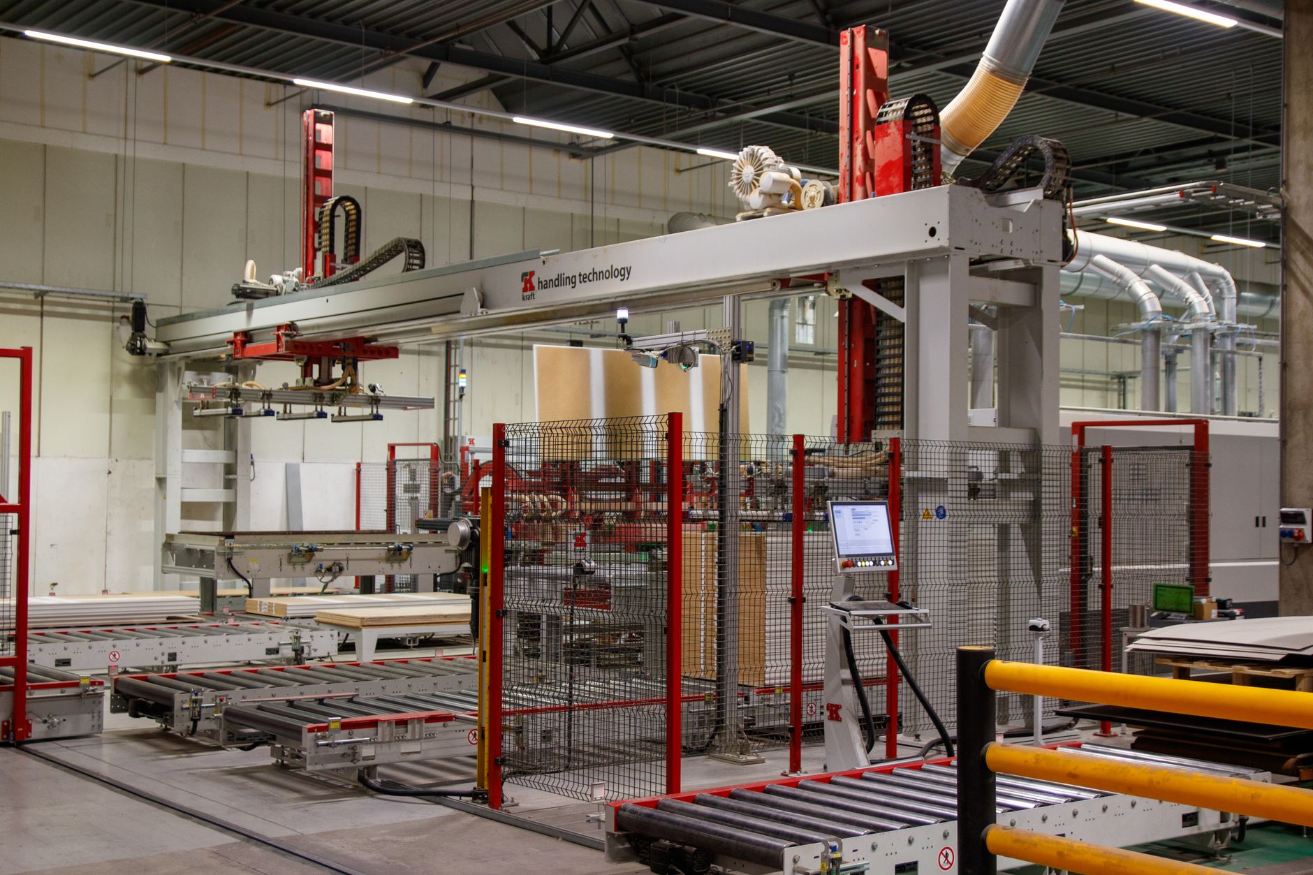 a compact lidar sensor array mounted on an industrial robotic arm inside a high-bay warehouse, with conveyor belts and shelving units visible in the background