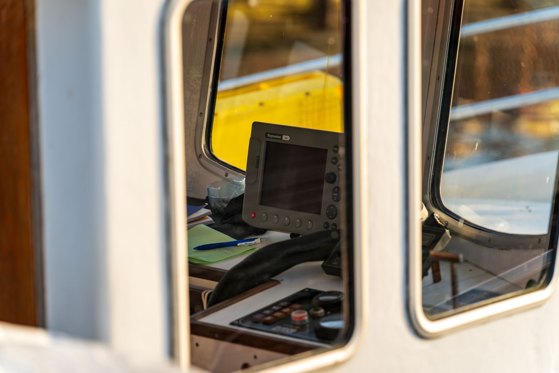 a modern ship bridge control room with multiple navigation screens displaying radar, GPS tracking, and real-time alert dashboards, no crew visible