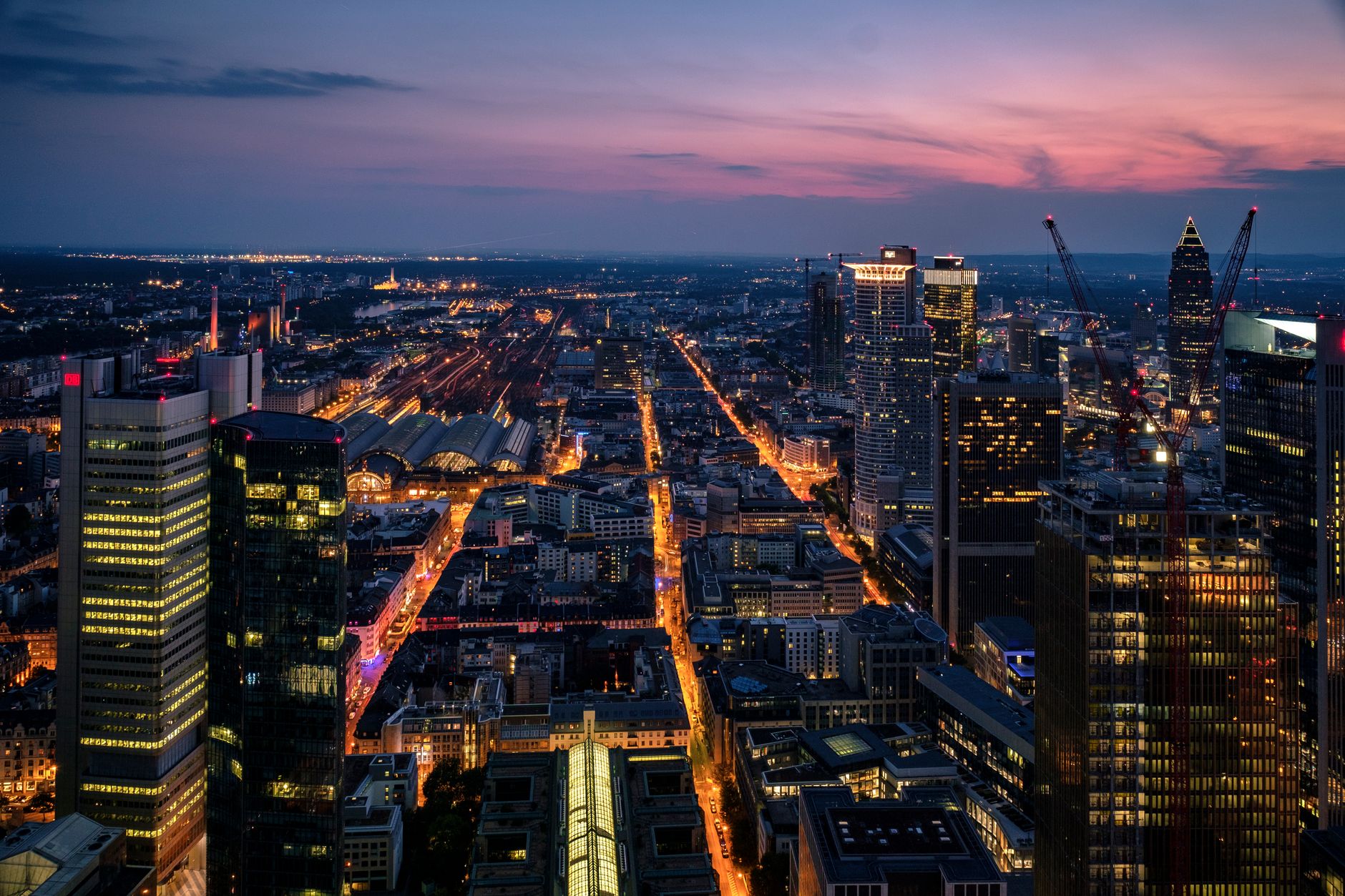 aerial view of central Paris financial district at dusk with office towers reflecting warm light across the Seine