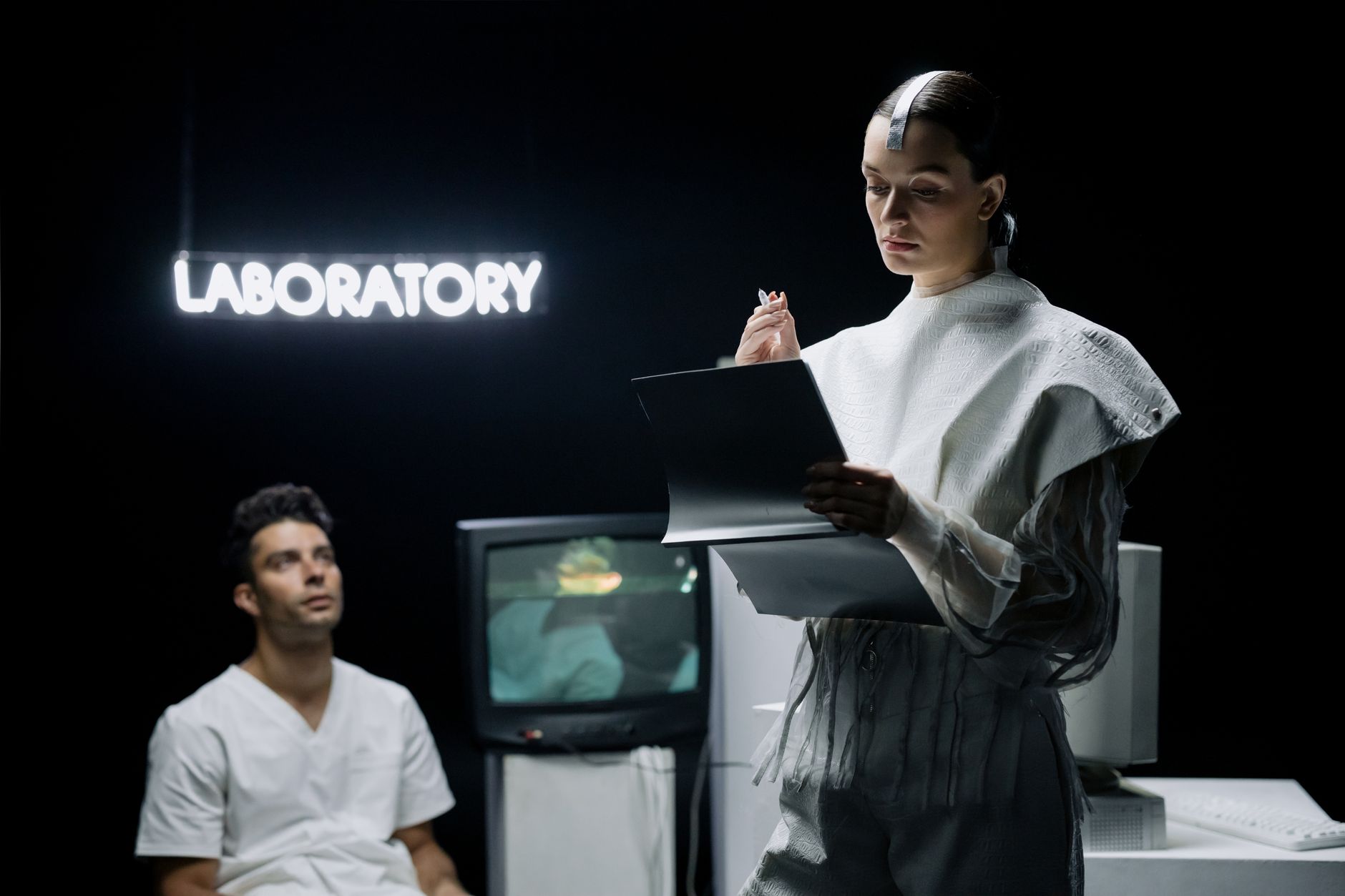 interior of a biomedical research facility with advanced electron microscopy equipment and glowing monitor displays showing cellular imaging data