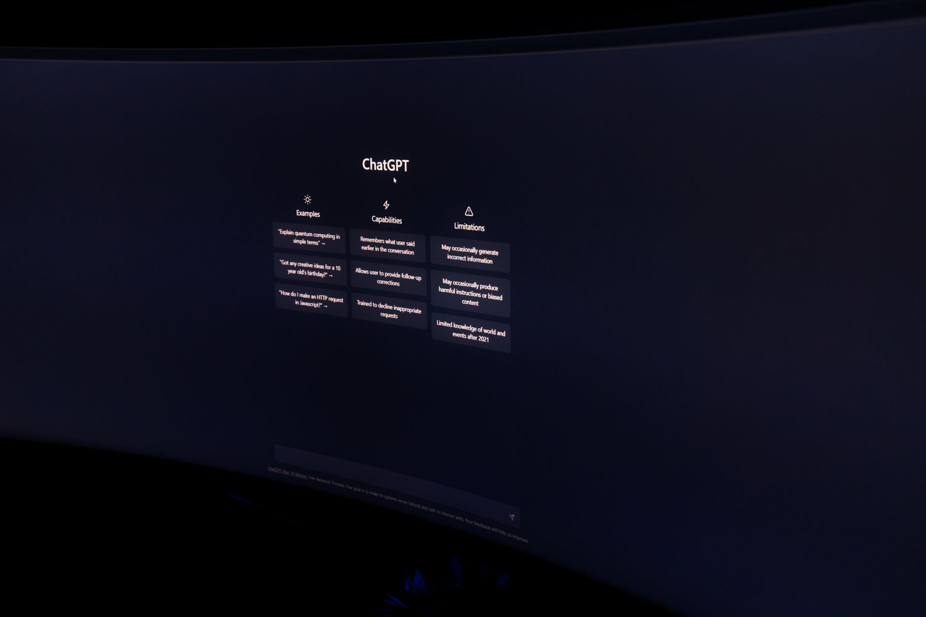 a wall of computer monitors displaying model cards and repository listings on a machine learning platform interface, photographed in a dimly lit office at night
