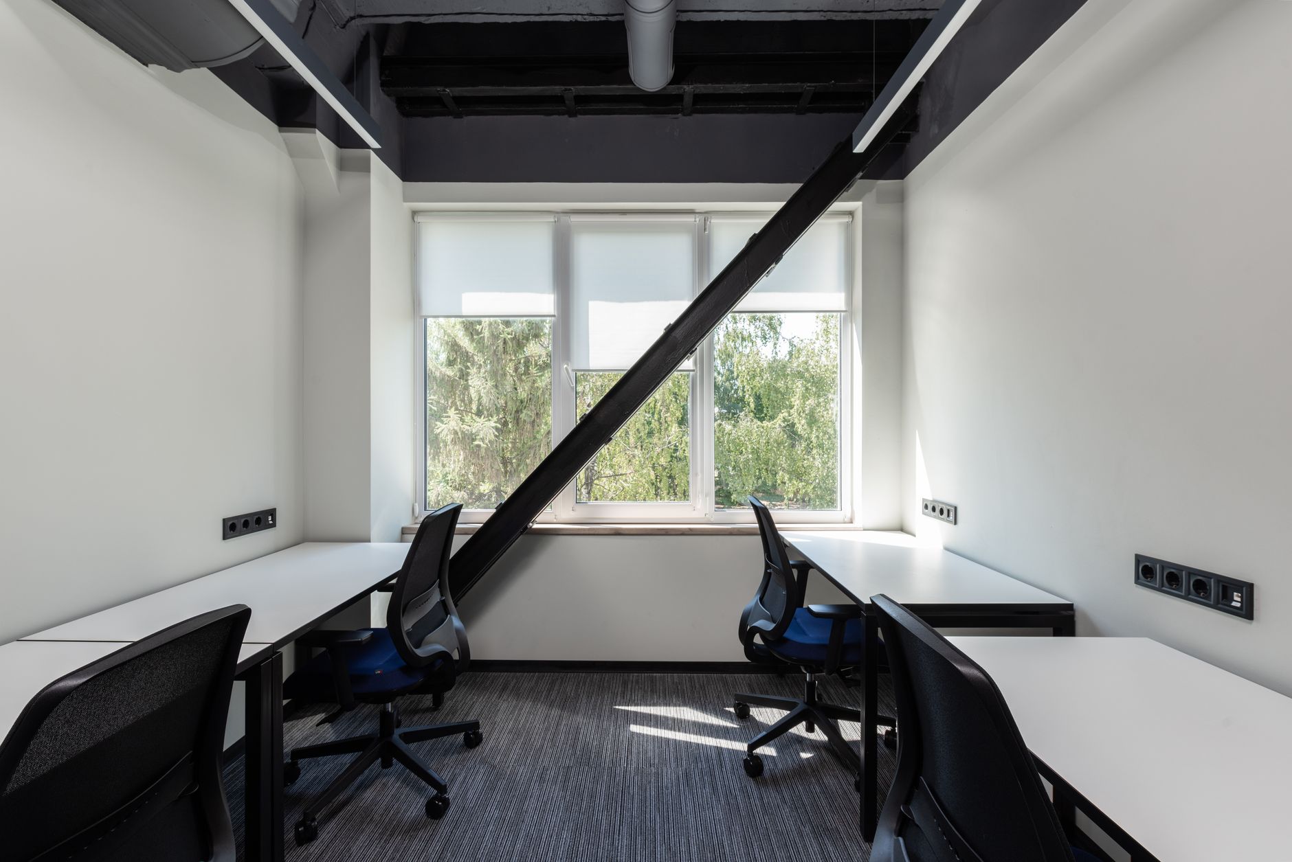 a modern venture capital office interior with floor-to-ceiling windows overlooking a city skyline, empty meeting table with laptops and pitch decks visible