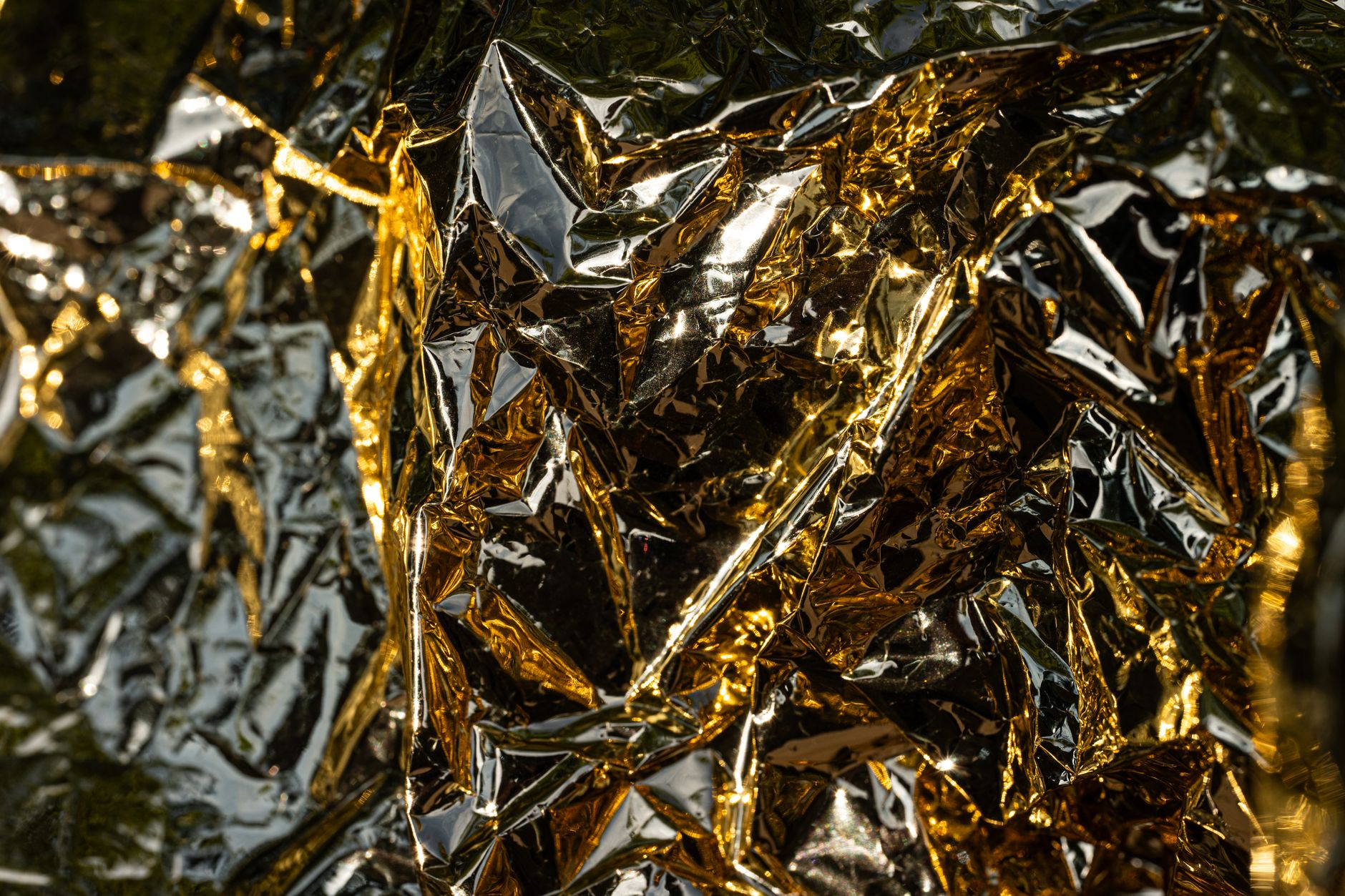 a small spacecraft in thermal vacuum testing chamber, with gold foil insulation and sensor cables running to external monitoring equipment