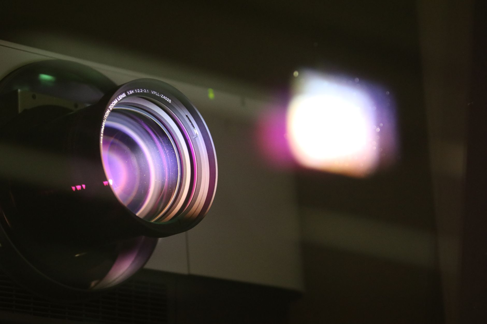 a close-up of an OLED TV screen showing vivid color gradients and deep shadow detail in a darkened home theater room