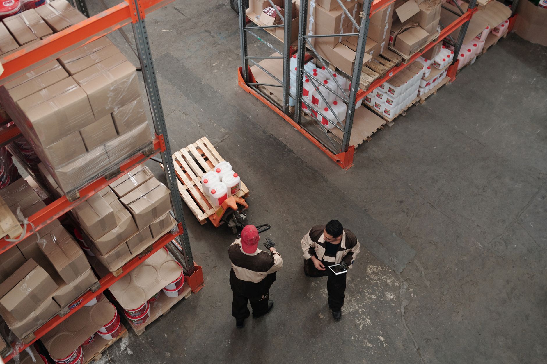 rows of packaged clothing parcels on a warehouse conveyor belt, viewed from above in a large distribution facility