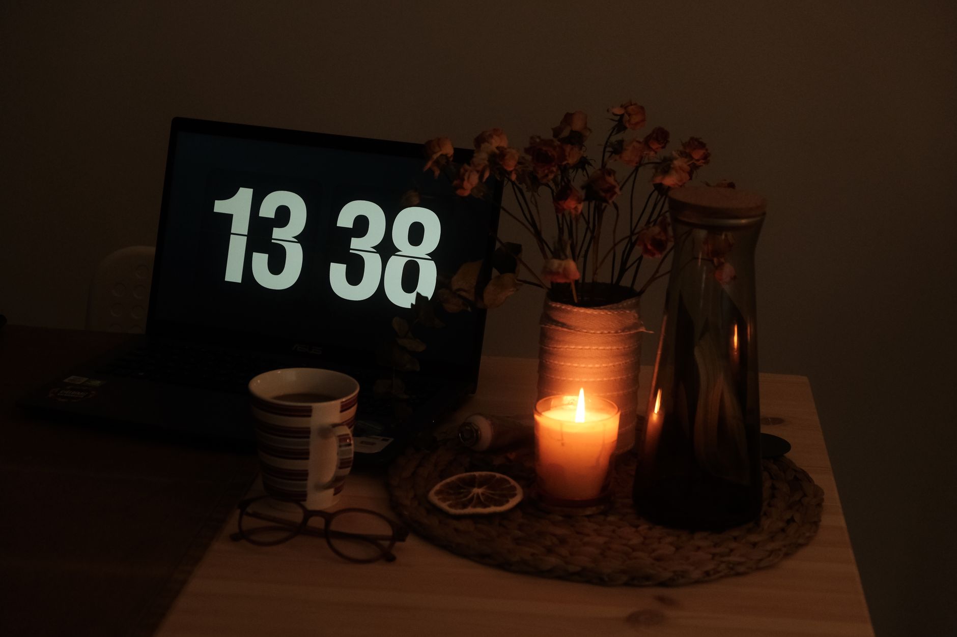 a laptop screen displaying a terminal window with package dependency trees and flagged repository entries, resting on a wooden desk in a dimly lit office