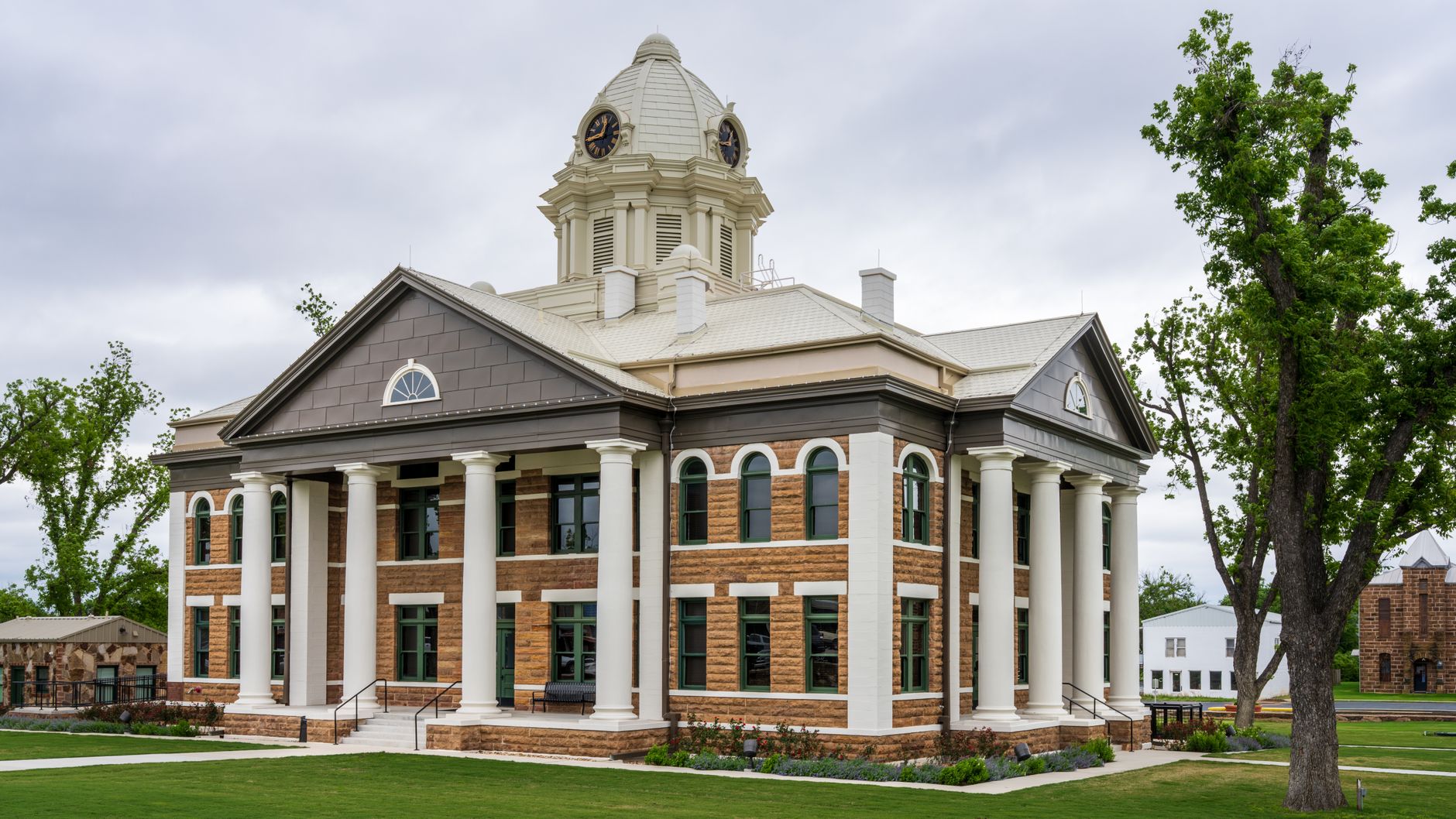 a state courthouse exterior with stone columns and steps in afternoon light, no signage visible