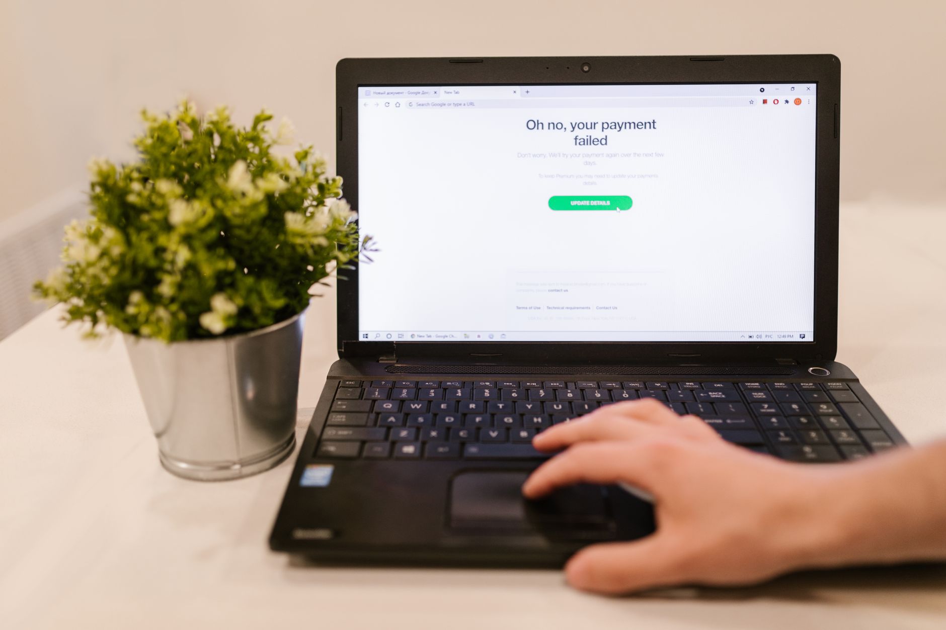 a close-up of a government-issue laptop screen showing an AI chat interface with redacted text fields, set on a secure desk with access badge nearby